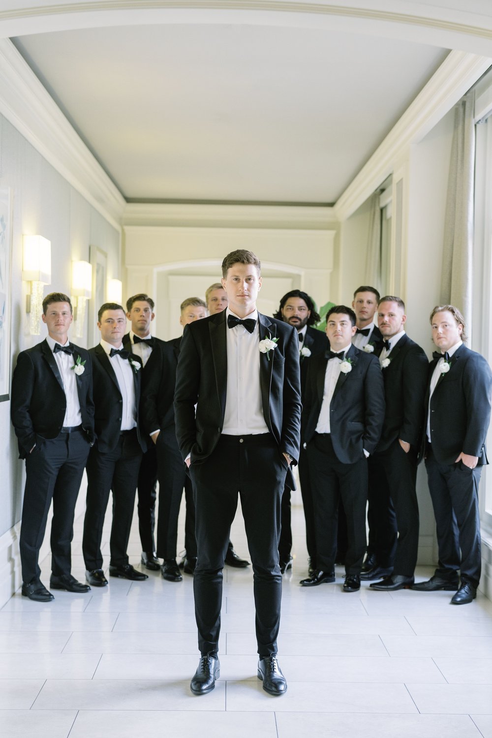 groomsmen inspiration at the ritz carlton in the white hallway .jpg
