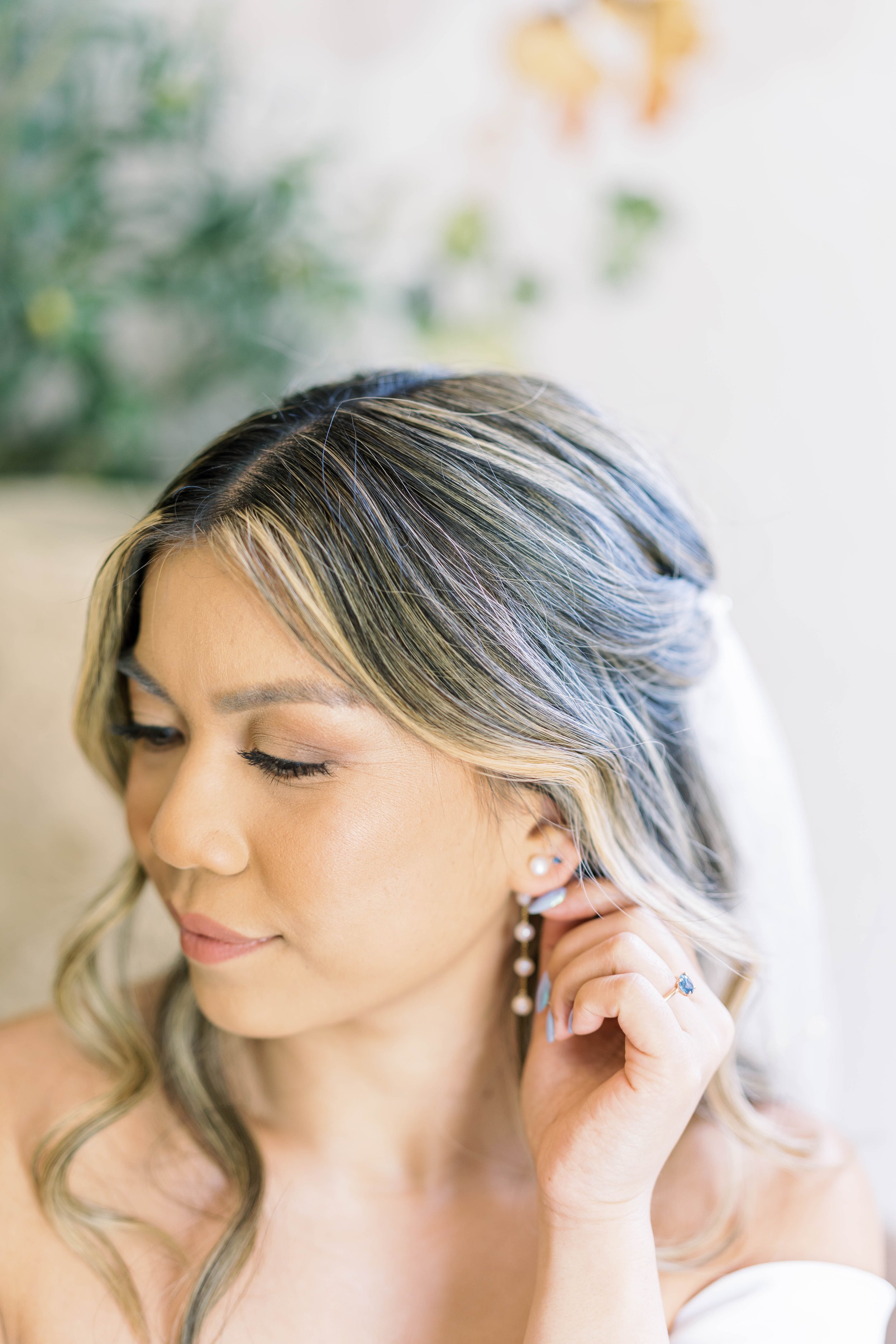 bride-getting-ready-putting-on-earrings.jpg