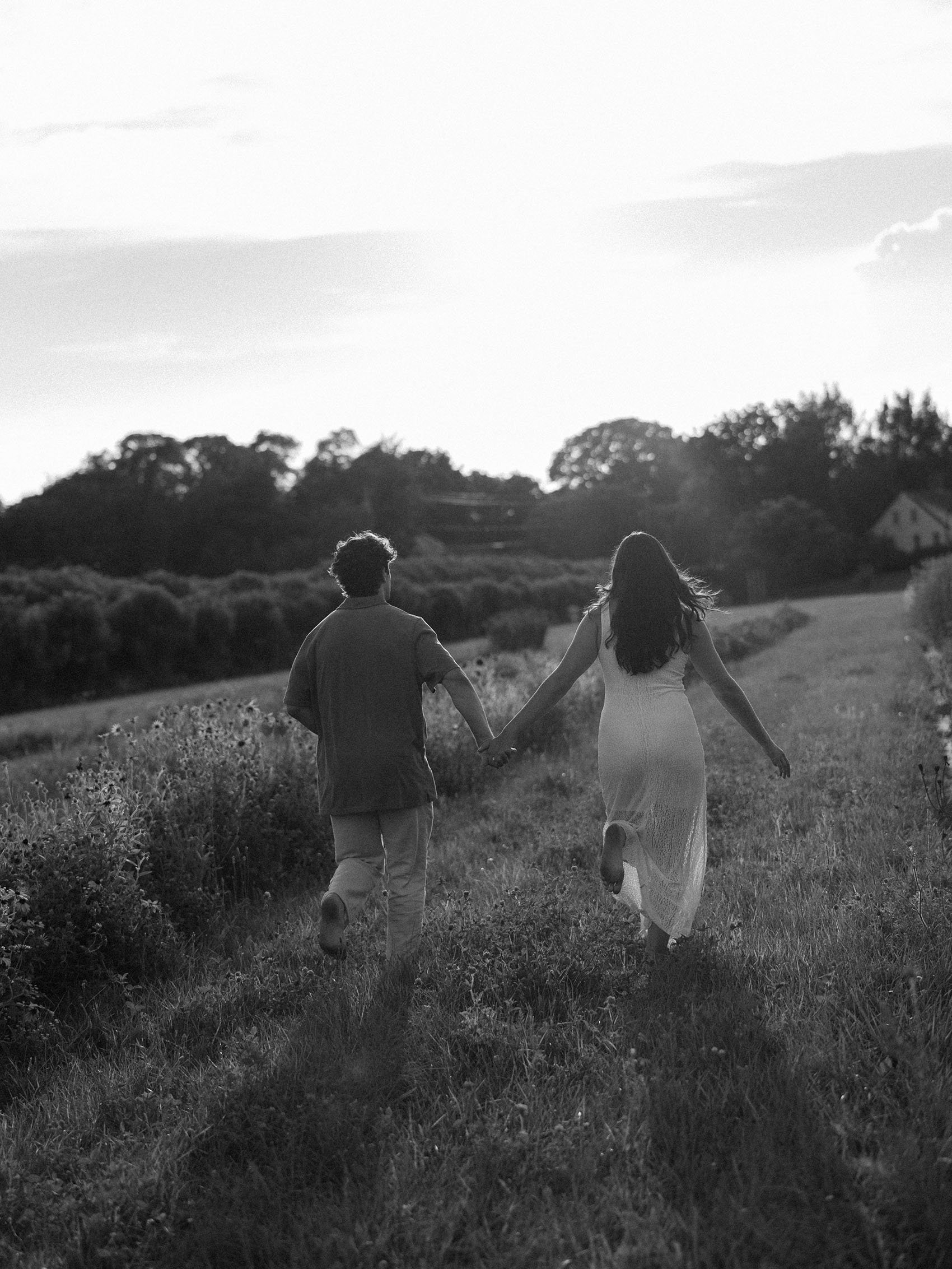 couple-running-through-flower-field-at-salt-air-farm.jpg