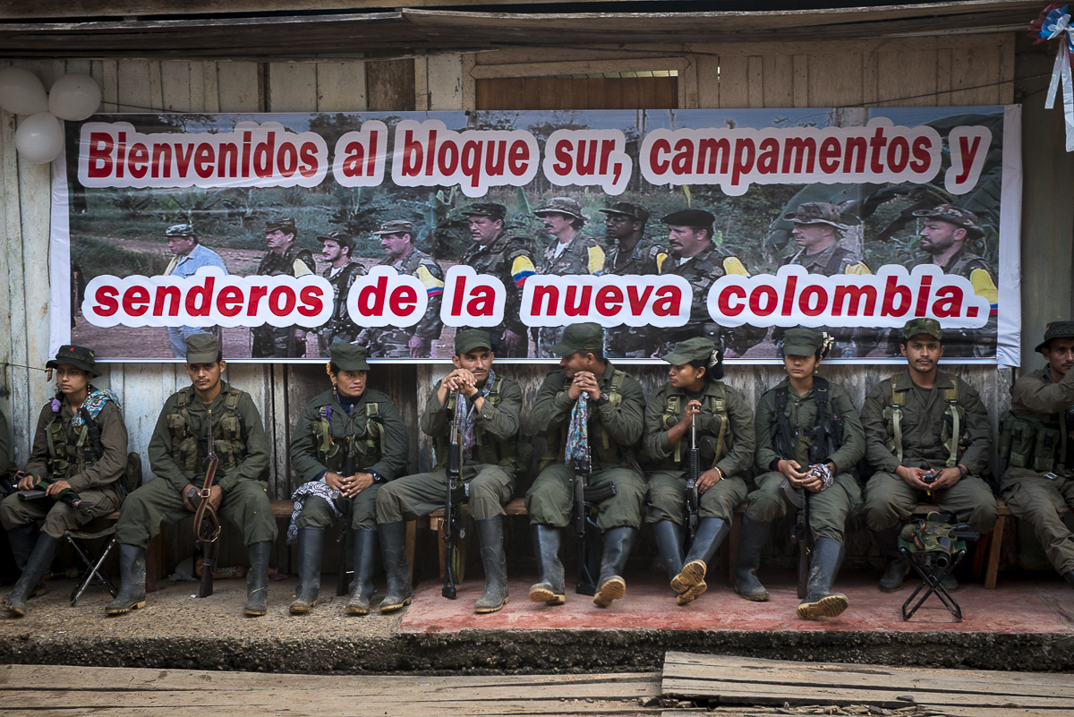 The guerrilleros are waiting to be assigned at a place during the public meeting between peace FARC delegation and civil population. The banner says: “Welcome to the southern Block, the camps and the pathways to a new Colombia”. All the fronts and the columns are represented in the event. (January 25, 2016, Putumayo)