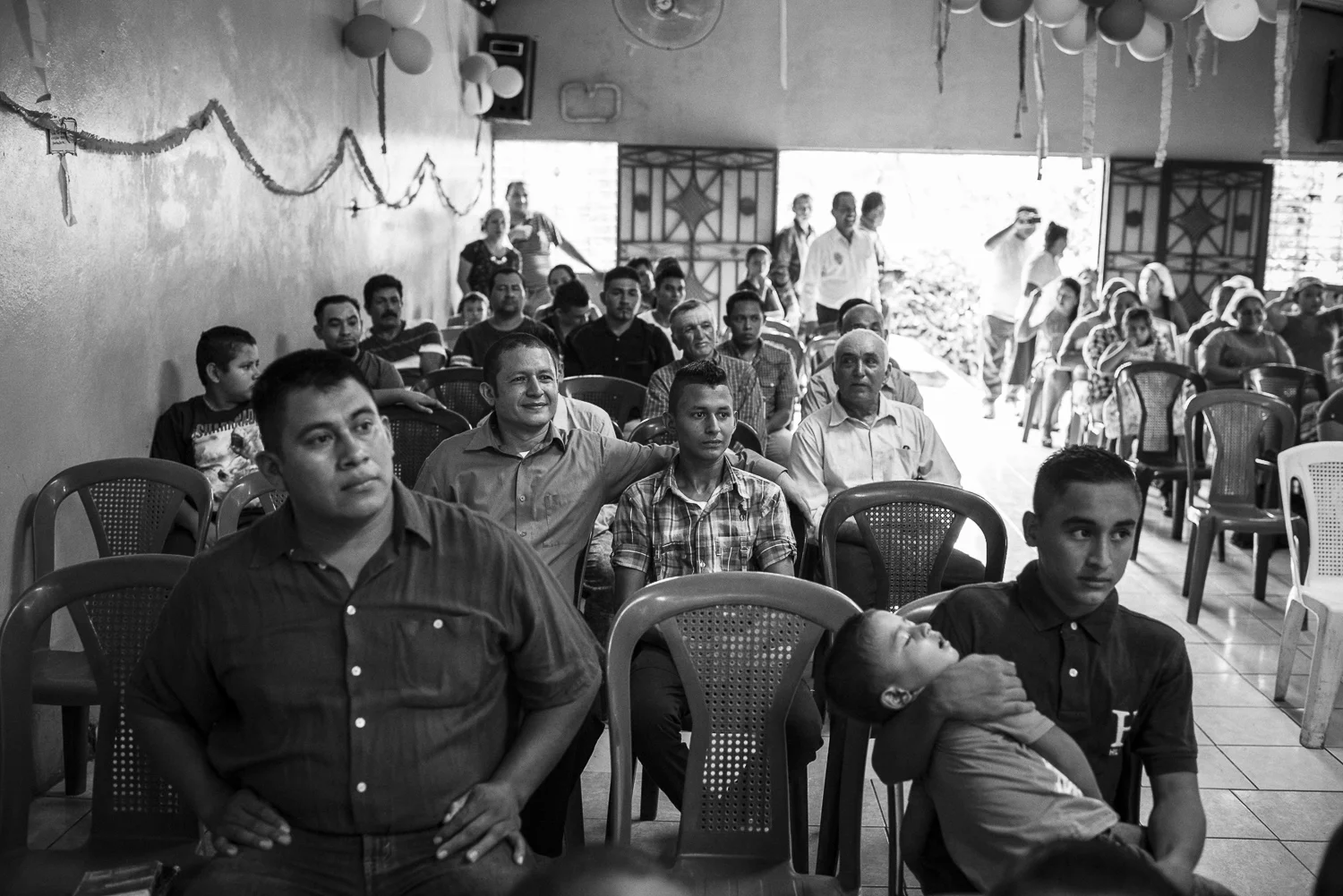 In a village north to San Salvador, Angel, former gang member of the 18, is attending to the worship with his son. He didn’t see him since five years. He was released ten days ago. Angel came to the village with others brothers to convert gang members. (El Salvador, October 08, 2017) Credit: Nadège Mazars / Hans Lucas studio