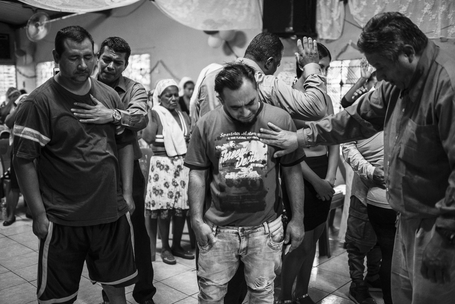 At Aguilares, in a village north to San Salvador, Uziel, former gang member of the 18, and Martin are preaching in area with gang’s presence. Uziel came with Angel and two others brothers, former gang members, to realize a “campaign” to convert gang members. During the day, he says that ten gang members came to them. (El Salvador, October 08, 2017) Credit: Nadège Mazars / Hans Lucas studio