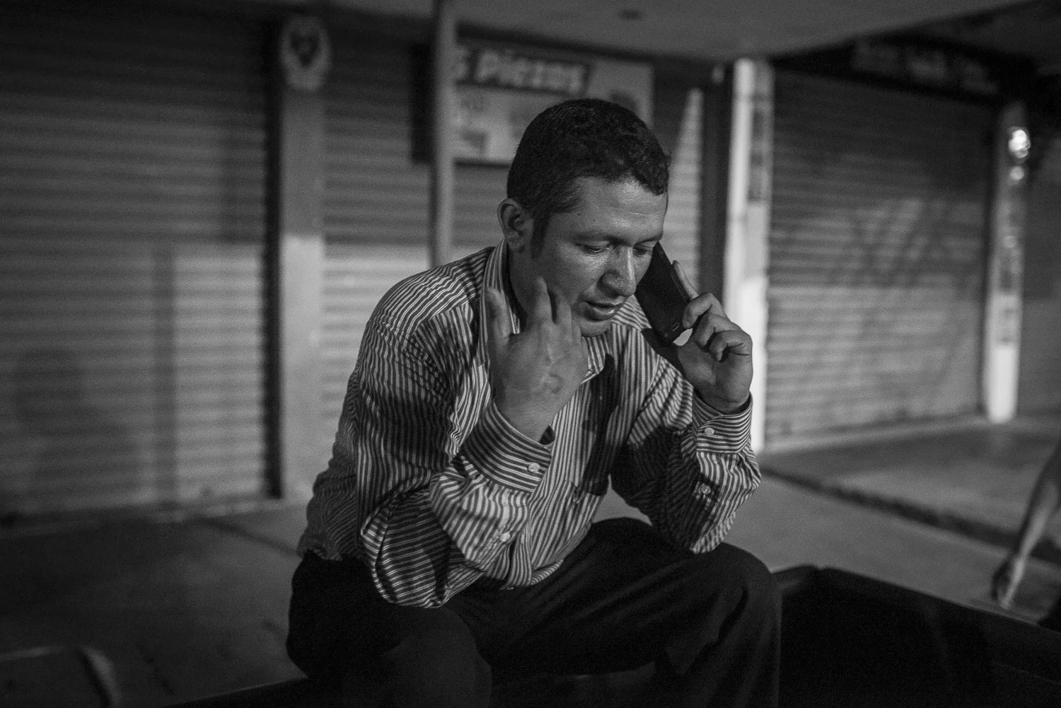 After preaching at Aguilares, Angel is calling some people. (April 14, 2018) Credit: Nadège Mazars / Hans Lucas studio