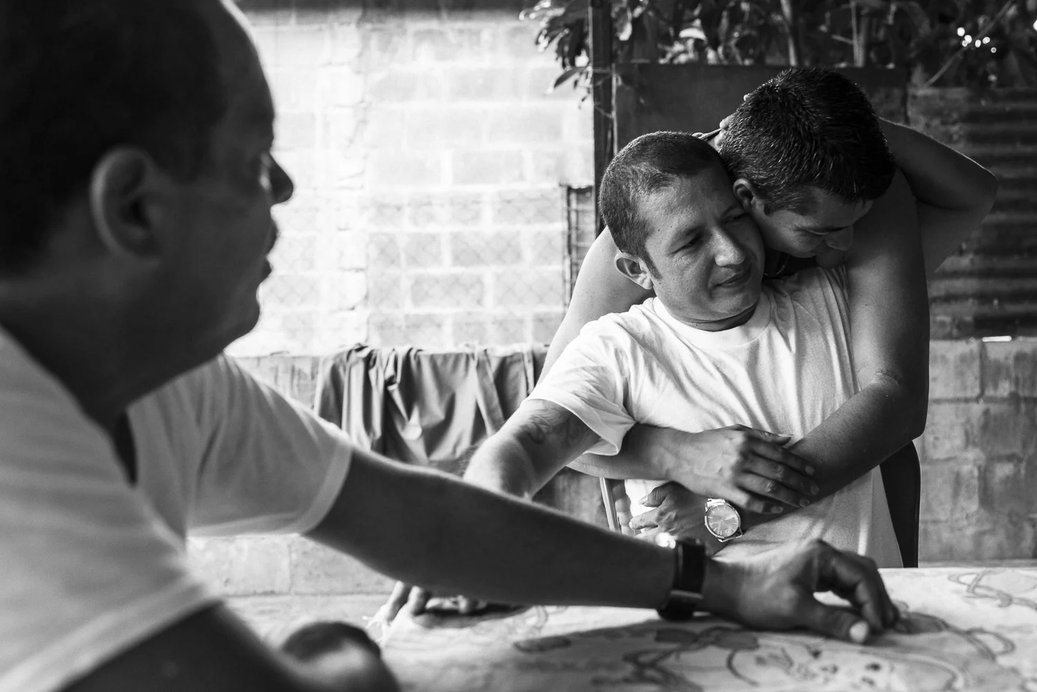 In a village north to San Salvador, Uziel embraces Angel. They were comrades from the same gang, the Barrio 18. They met again recently, when Angel was released. (October 8, 2017) Credit: Nadège Mazars / Hans Lucas studio