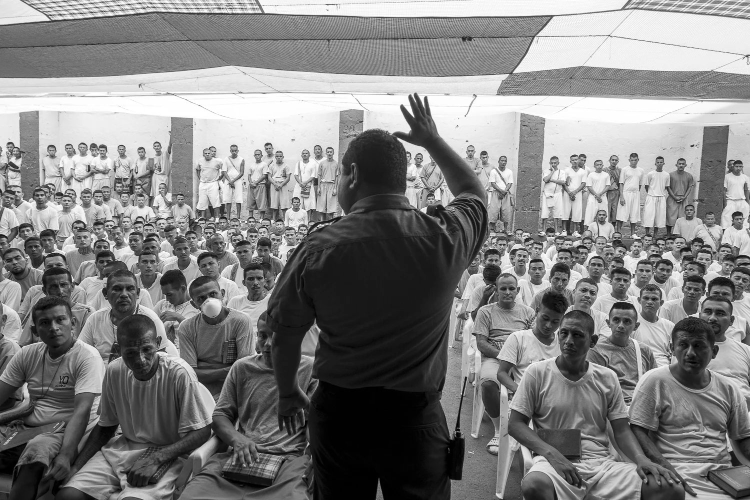 At the 1,2 and 3 yards of the jail, the director, Oscar David Benavides Bermudez, gives a speech to the prisonners. This part of the jail is recently converted to Christianity. (San Francisco de Gotera, El Salvador, April 19, 2018) Credit: Nadège Mazars / Hans Lucas studio