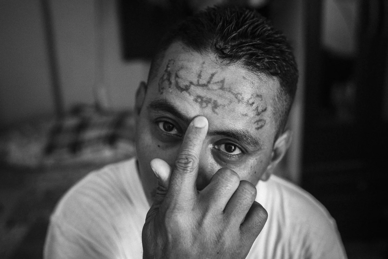 Jose Rolando shows his tattoos being erased. He followed 34 laser sessions to remove the signs of this former belonging to the “18” gang. He is a former gang member converted to evangelism. (San Salvador, April 4, 2017) Credit: Nadège Mazars / Hans Lucas studio