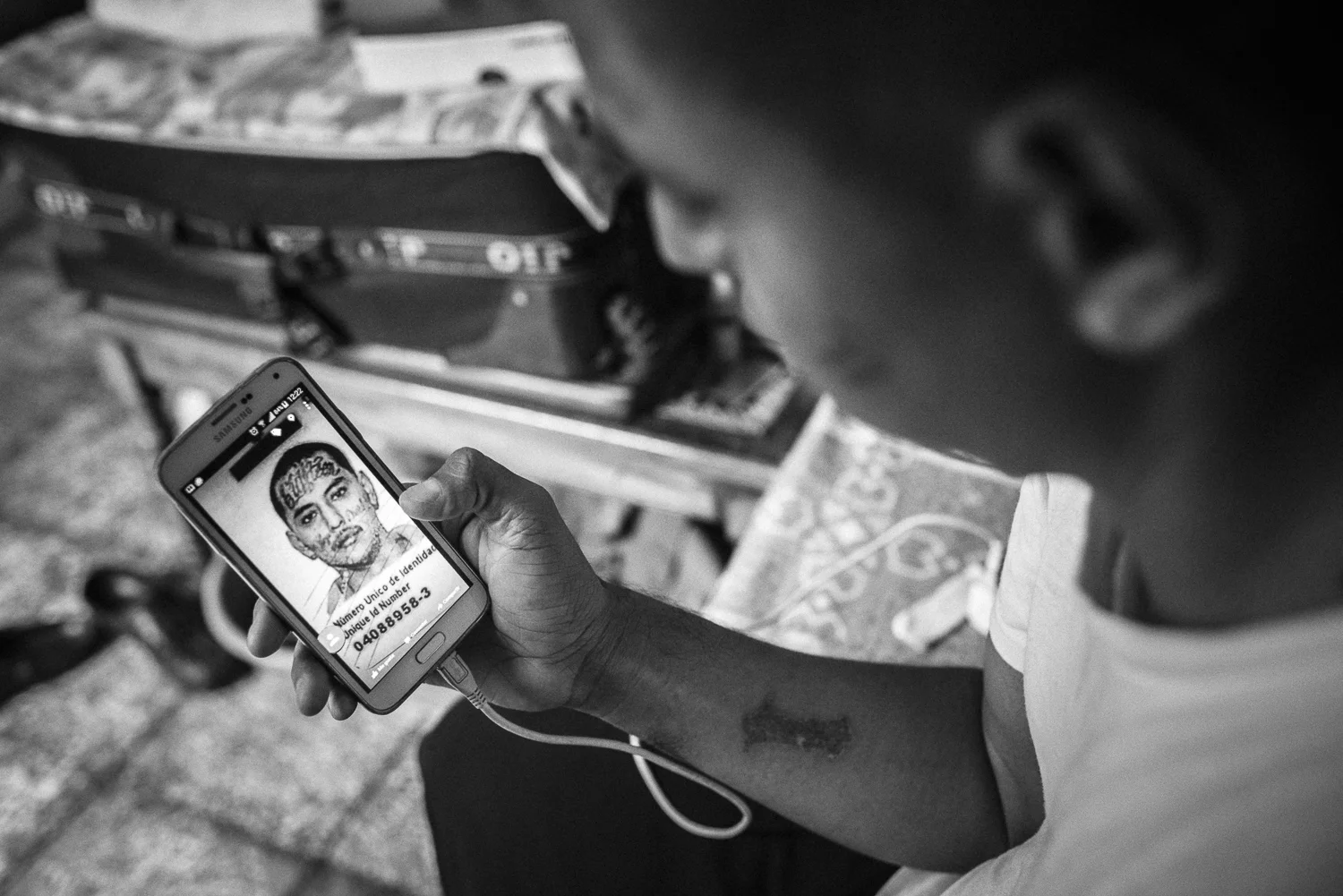 Jose Rolando lived at the Eber Ezer church since 28 months before leaving to his own place on May 2017. He followed 34 laser sessions to remove his tattoos, on the body and the face. The “Eighteen” tattoo, name of his former gang, is almost removed. On his cheeks, the tattoo “Viva mi raza 18” (“Long life to my race 18”) is totally removed. (Colonia Dina, San Salvador, April 04th, 2017) Credit: Nadège Mazars / Hans Lucas studio