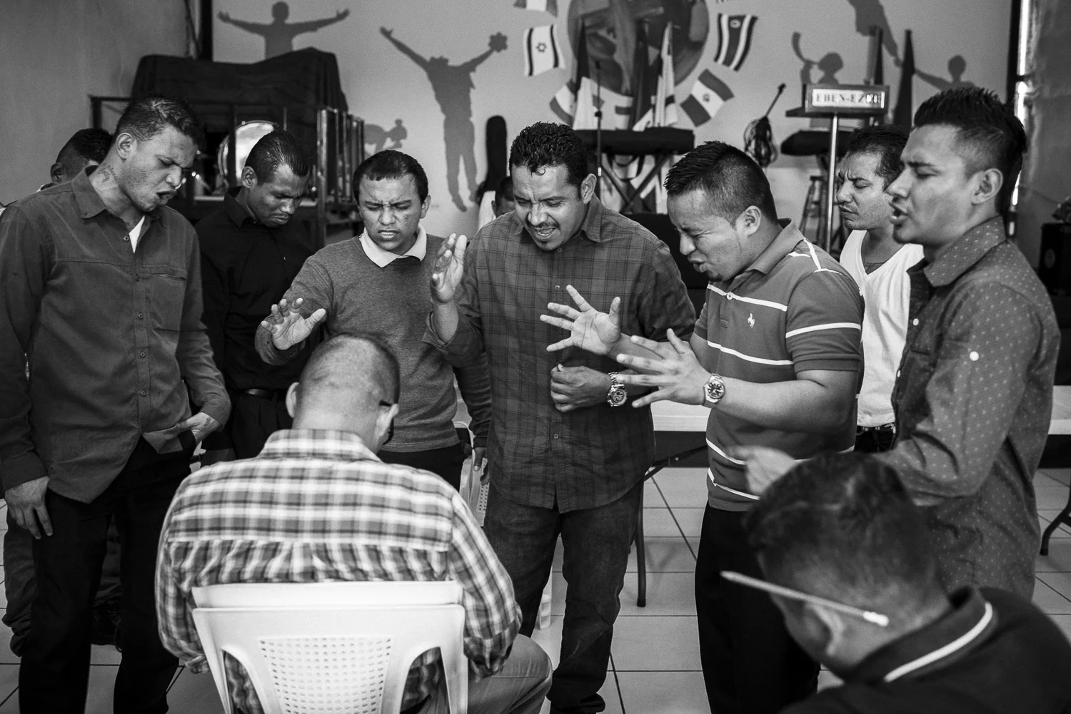 Former gang members are praying for a new brother coming to the church. (San Salvador, July 11, 2017) Credit: Nadège Mazars / Hans Lucas studio