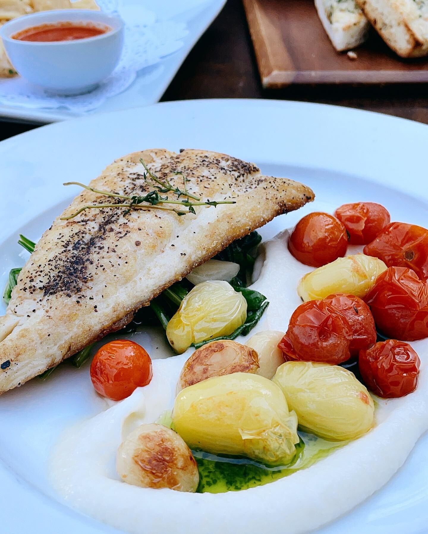 Fish is always a good idea for resetting after a long weekend of indulgence! ✨ Let us ease you back into the work week with our Branzino 🎣 with a creamy cauliflower pur&eacute;e, charred cherry tomatoes, garlicky spinach and topped with a crunchy sa