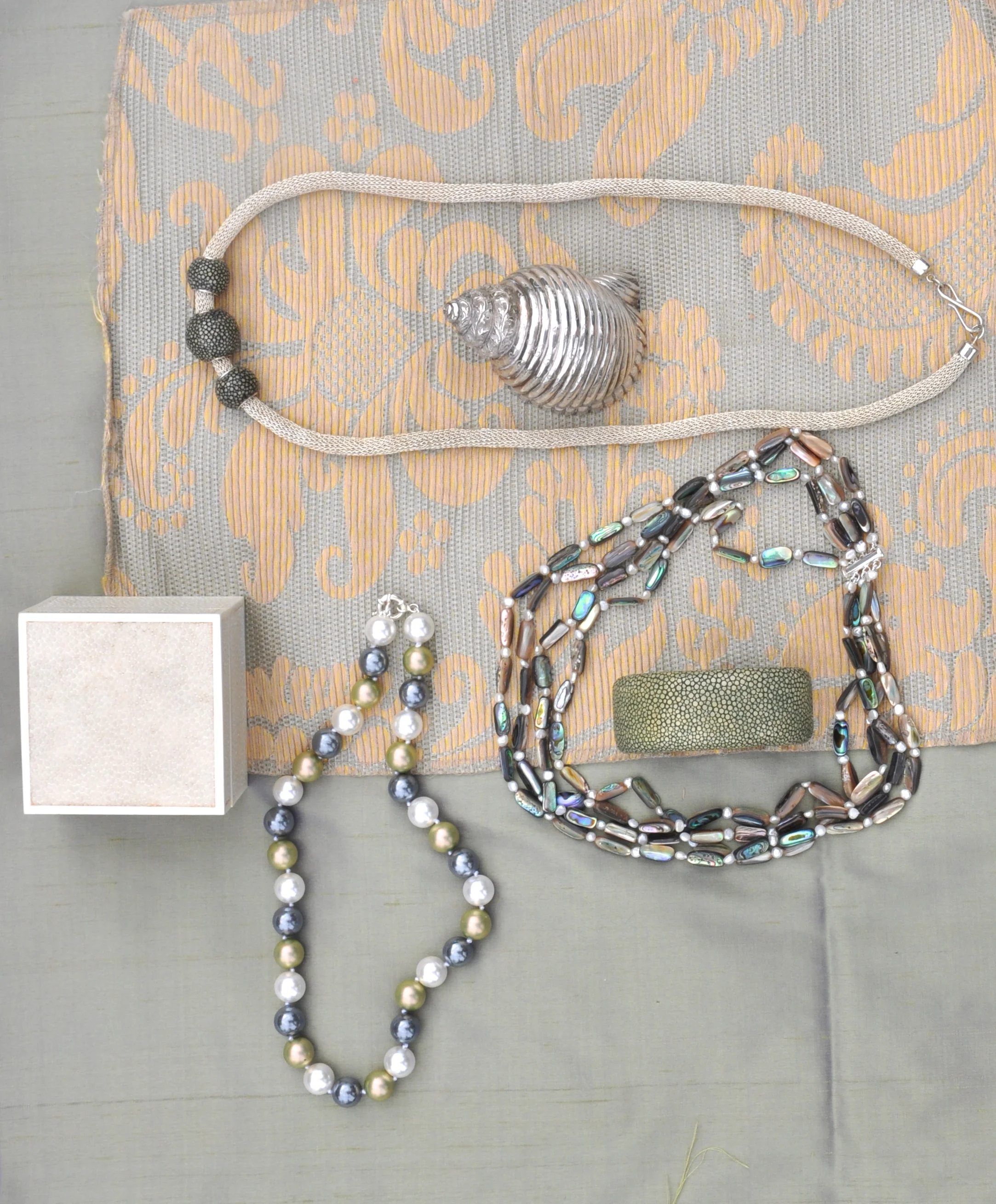 TOP LEFT: shagreen bead and silver mesh chain, CENTER: RIGHT: 4 strands abalone shell and freshwater pearls w/ shell clasp, shagreen cuff, BOTTOM LEFT-multi color pearl 20″ necklace w/ sterling clasp, shagreen box-special order