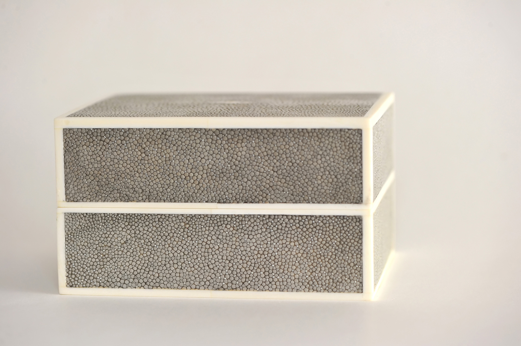 Slate Shagreen Box with Bone Detail- $510 Today shagreen is still used for the same sort of items as in the 17th and 18th centuries however many designers use faux shagreen instead since the material is quite expensive. Look at this handsome ottoman from Bunny Williams Home. She uses a faux shagreen on the center tray. What a perfect name, Tray Chic Ottoman!