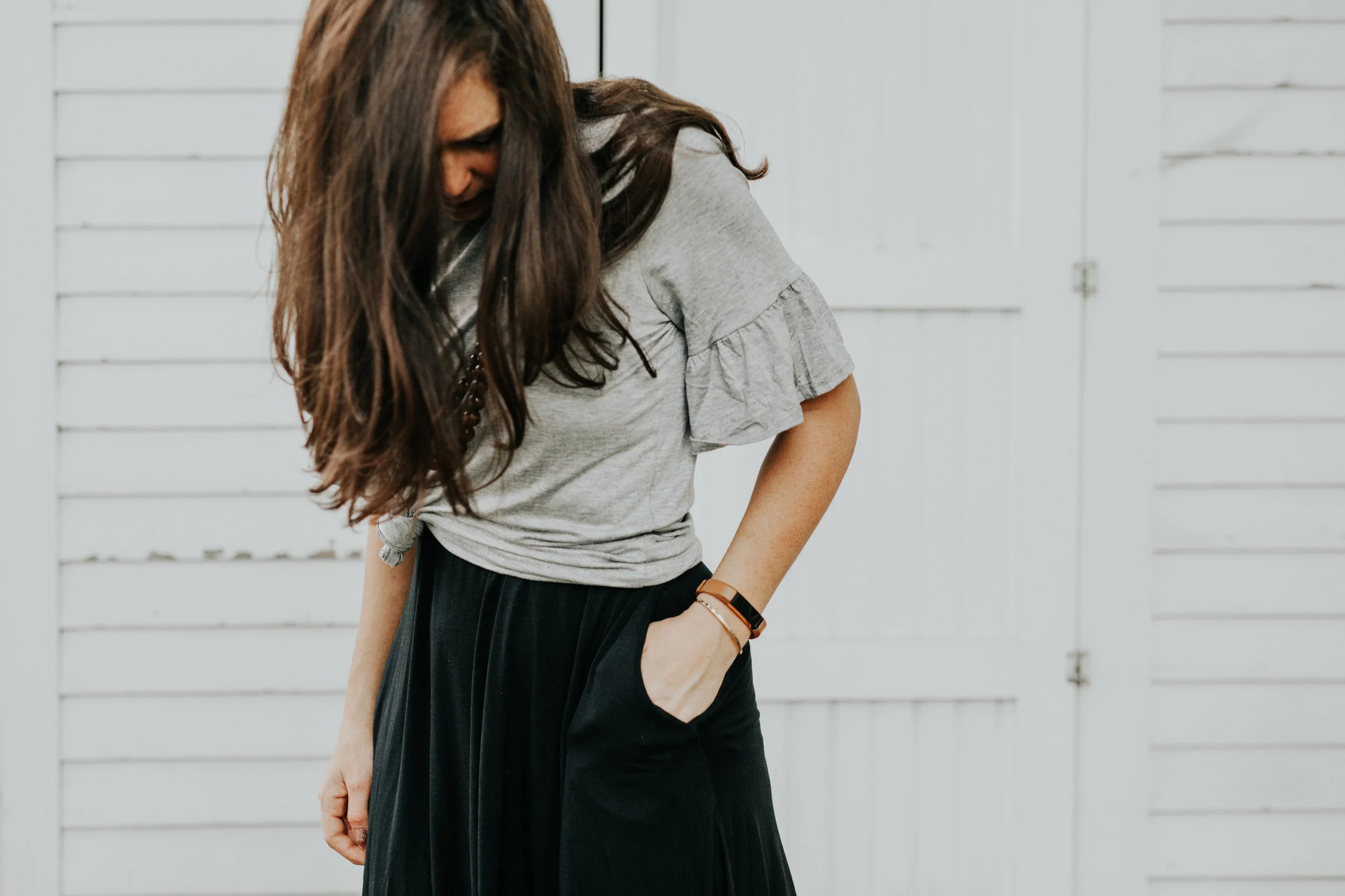 bell sleeve top over black dress