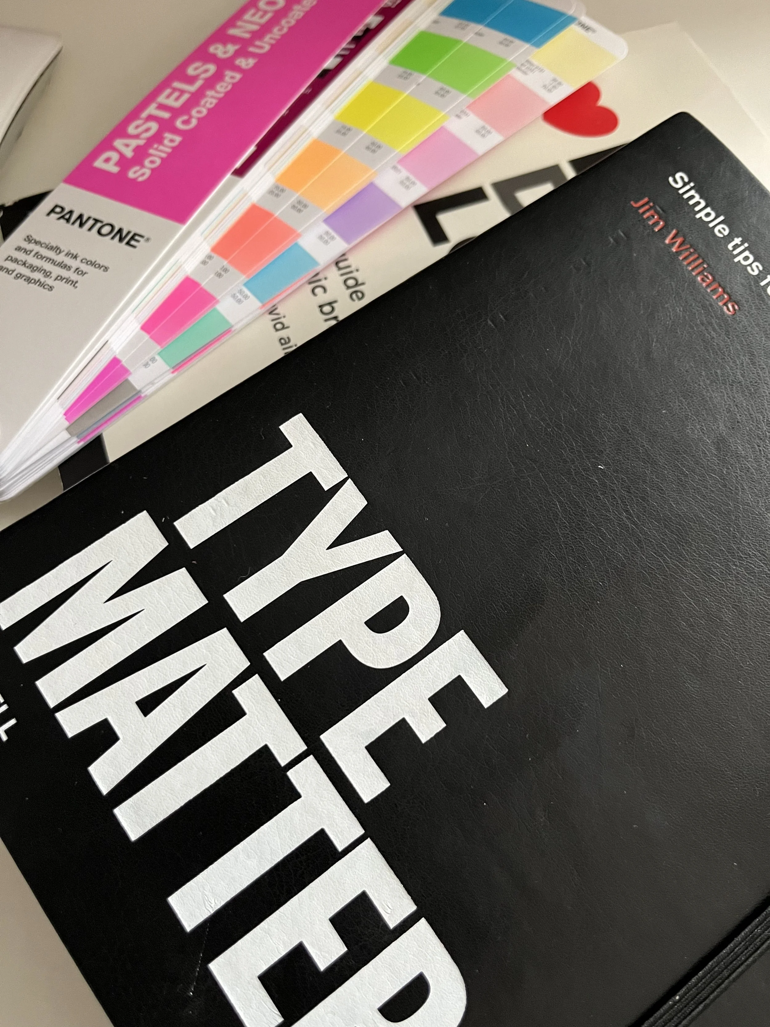 Typography reference material and colour swatches used during the design process