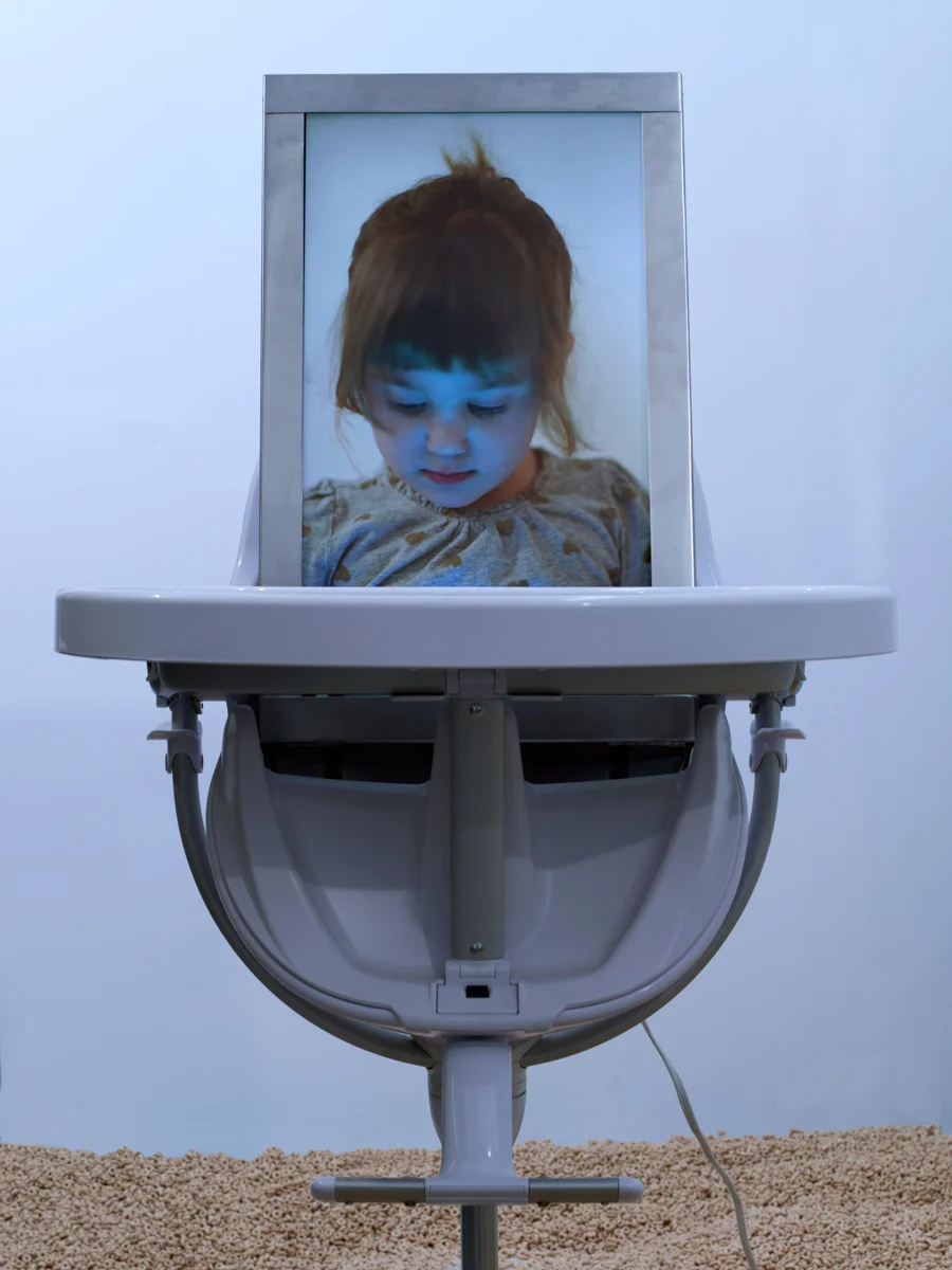 5-Hovnanian-Rachel-Lee_In-Loco-Parentis_2014_Installation-with-rear-projection-video-HD-video-acrylic-Cheerios-refridgerator-high-chair-metal-diamond-dust_Dimensions-Variable_Detail-View-1.jpg