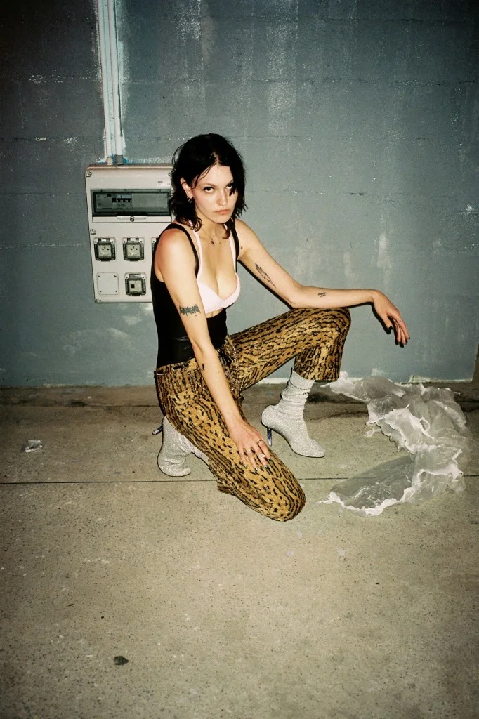  Sasha Melnychuk (Model) wears JAKUB POLANKA bodysuit, model’s own pants, MADE BY DAWN bra, and VETEMENTS boots. 