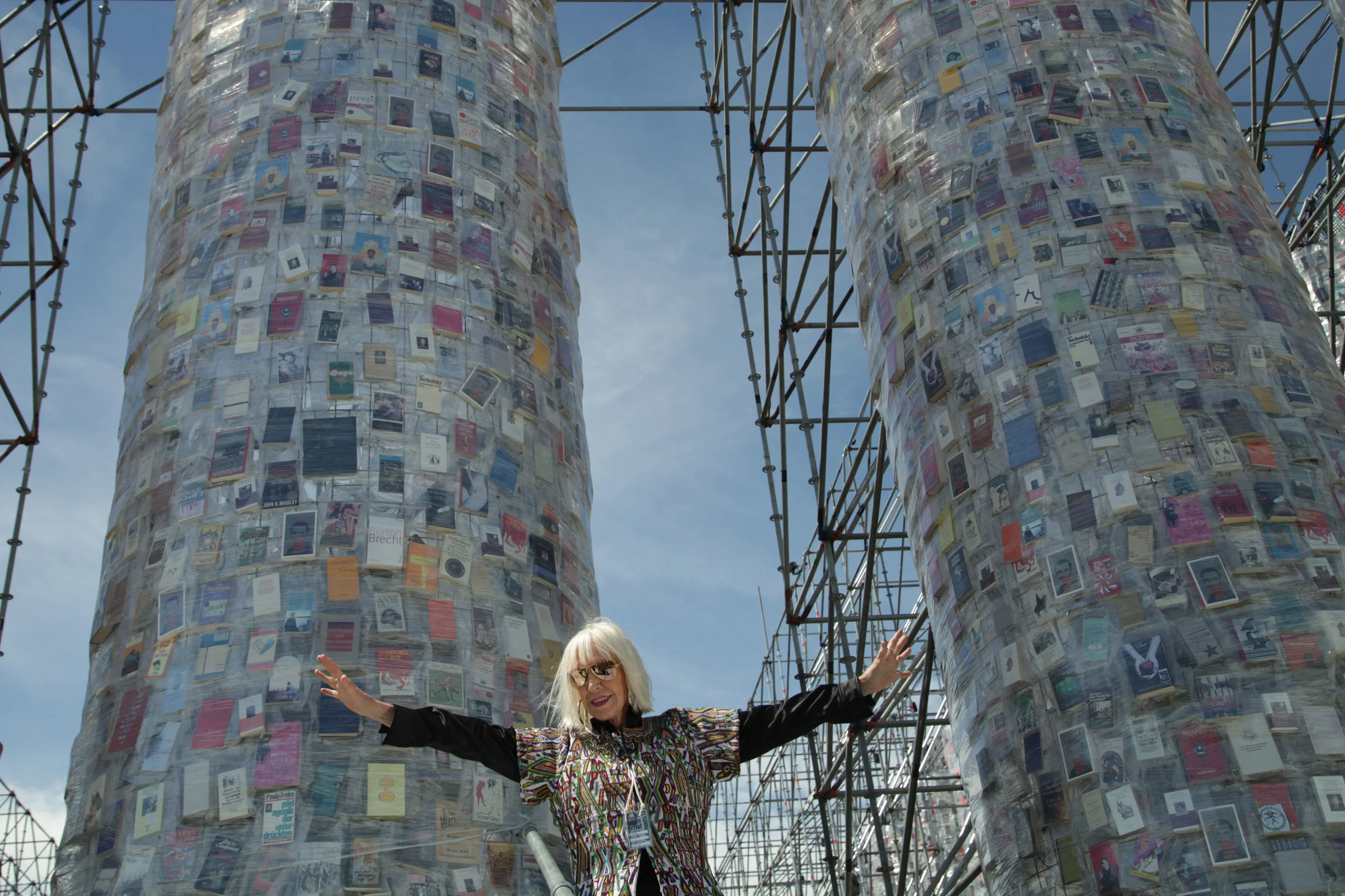 Marta Minujín poses in front of "The Parthenon of Books" 