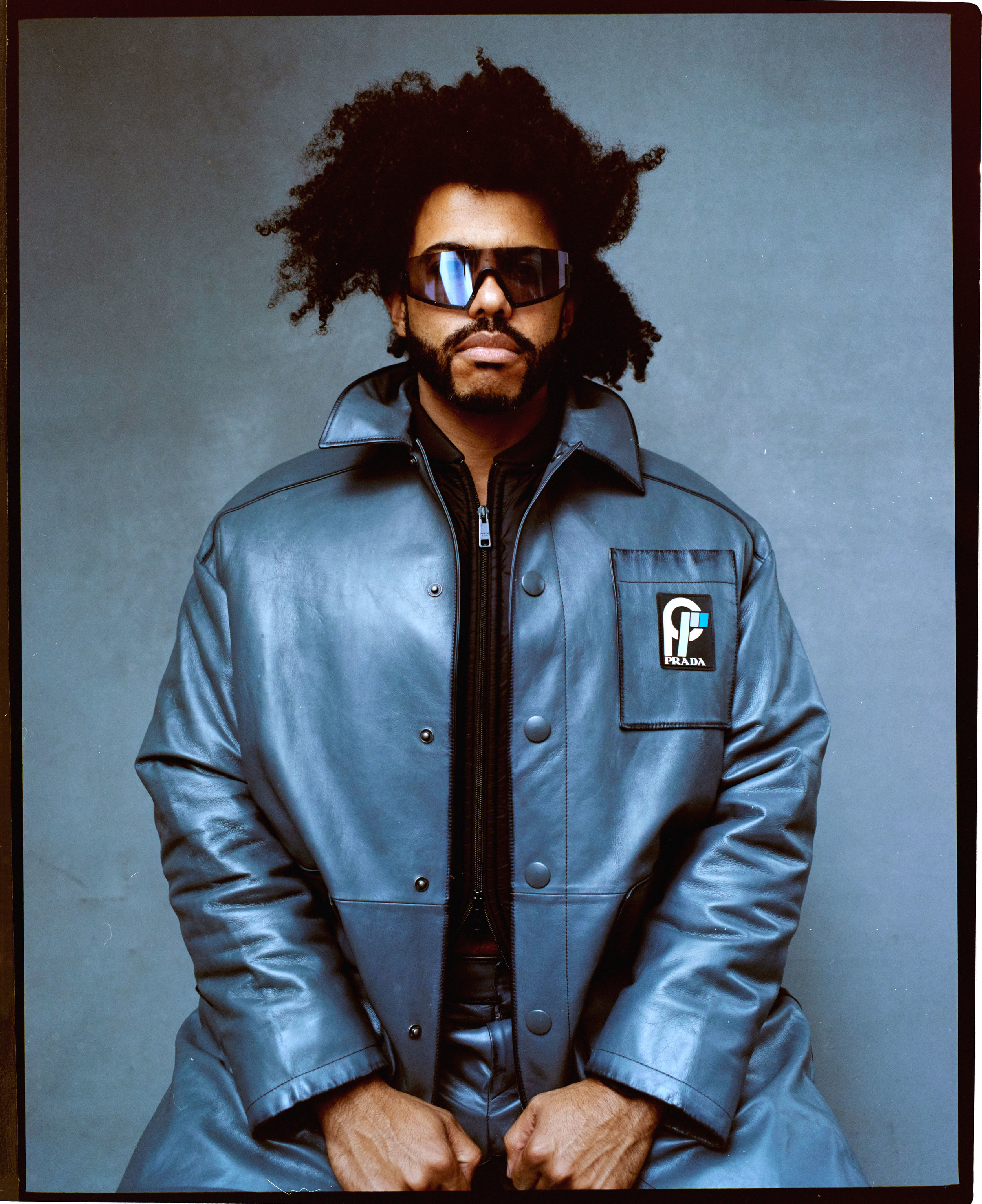   PRADA  jacket and shorts and  WESTWARD LEANING  sunglasses. 