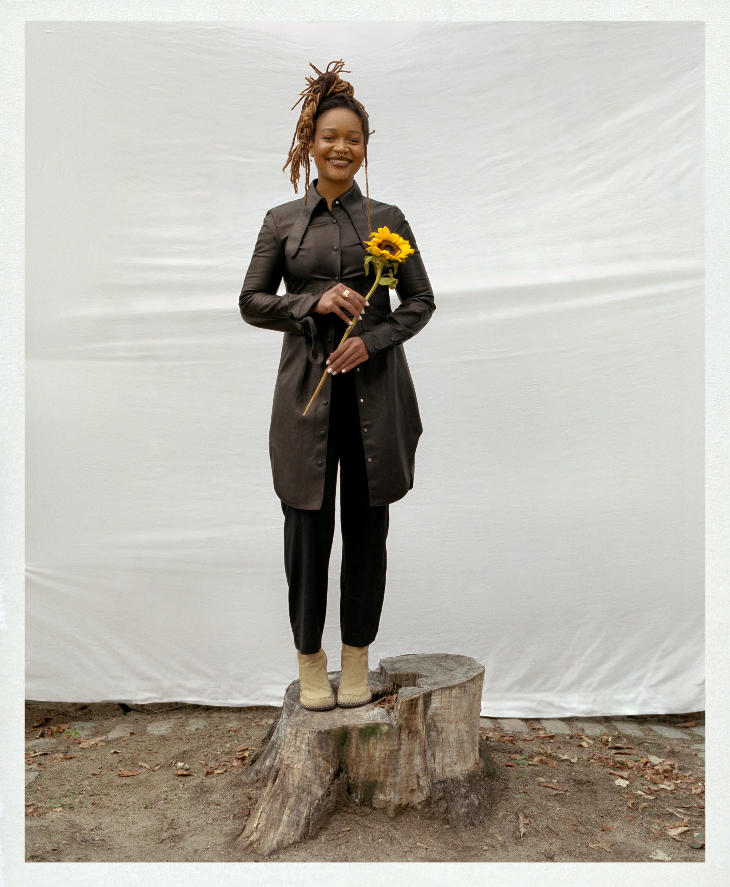 LOEWE shirt and pants, JW ANDERSON boots, and talent’s own jewelry.