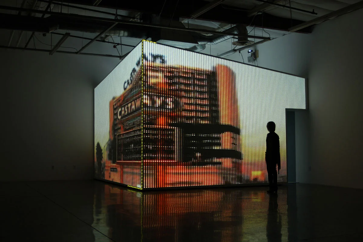 CAYETANO FERRER. INSTALLATION DETAIL, “CASINO MODEL 3” (2010). DRYWALL ROOM, CEILING TILES, HD PROJECTIONS, DYE- SUBLIMATED PRINT ON CARPET. DIMENSIONS VARIABLE. COURTESY THE ARTIST.