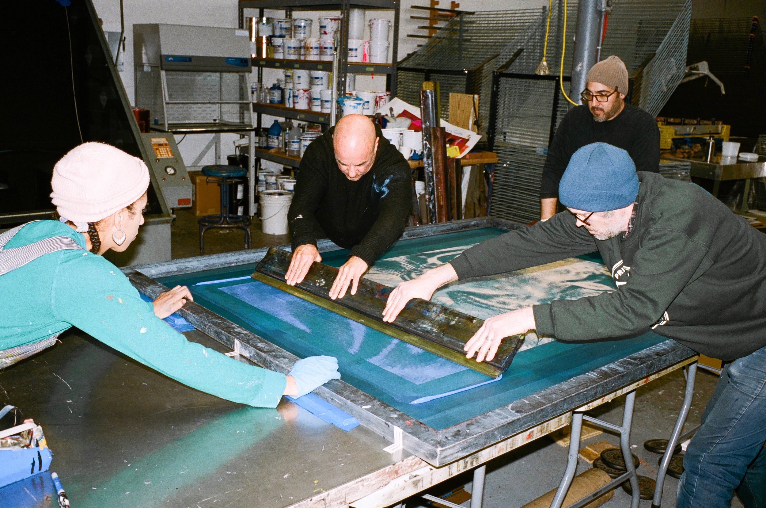 Russell and Luther in the silk-screen printing process.