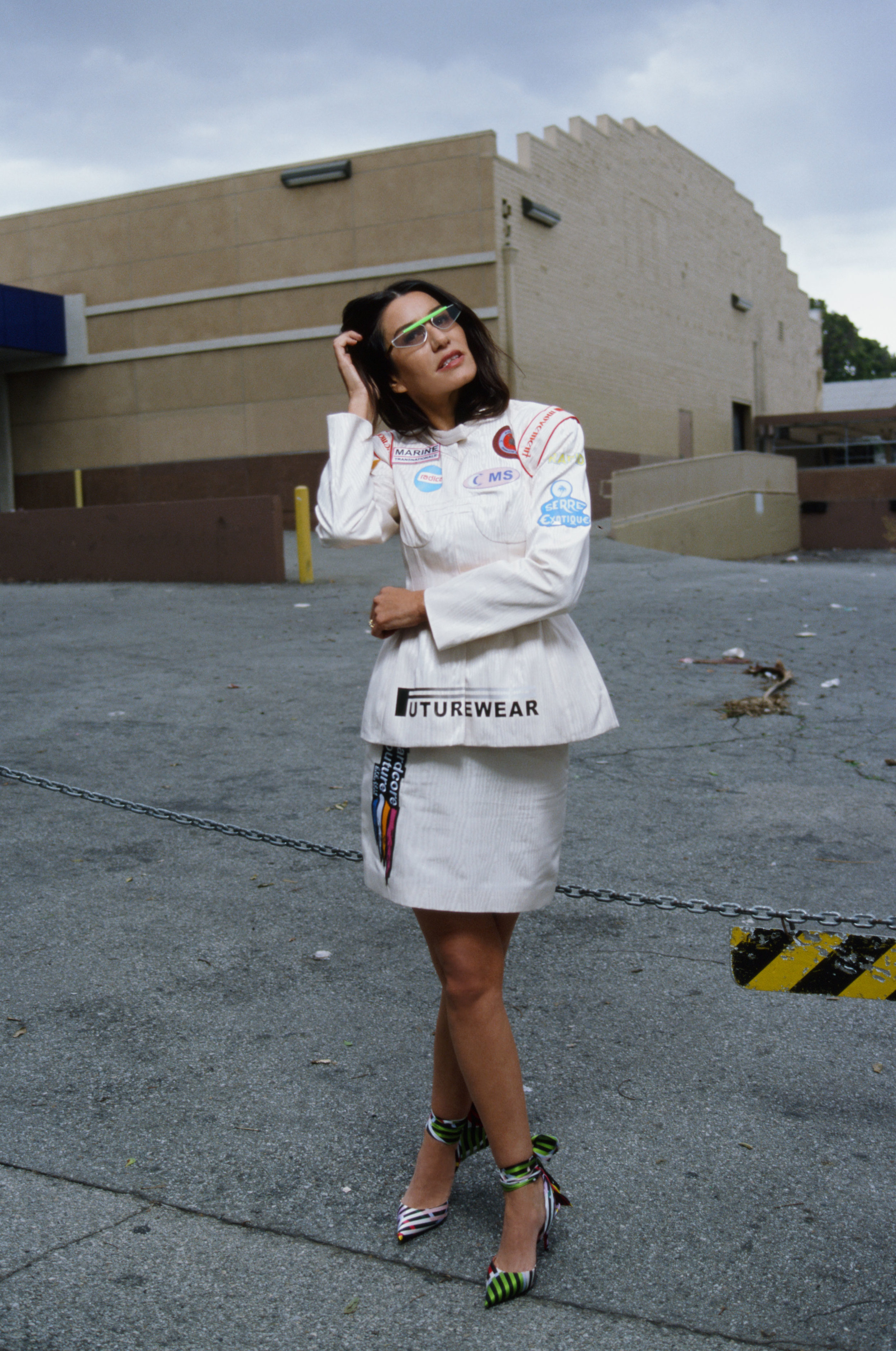 MARINE SERRE jacket and skirt available at MatchesFashion.com , CHRISTIAN LOUBOUTIN shoes, and GENTLE MONSTER sunglasses.