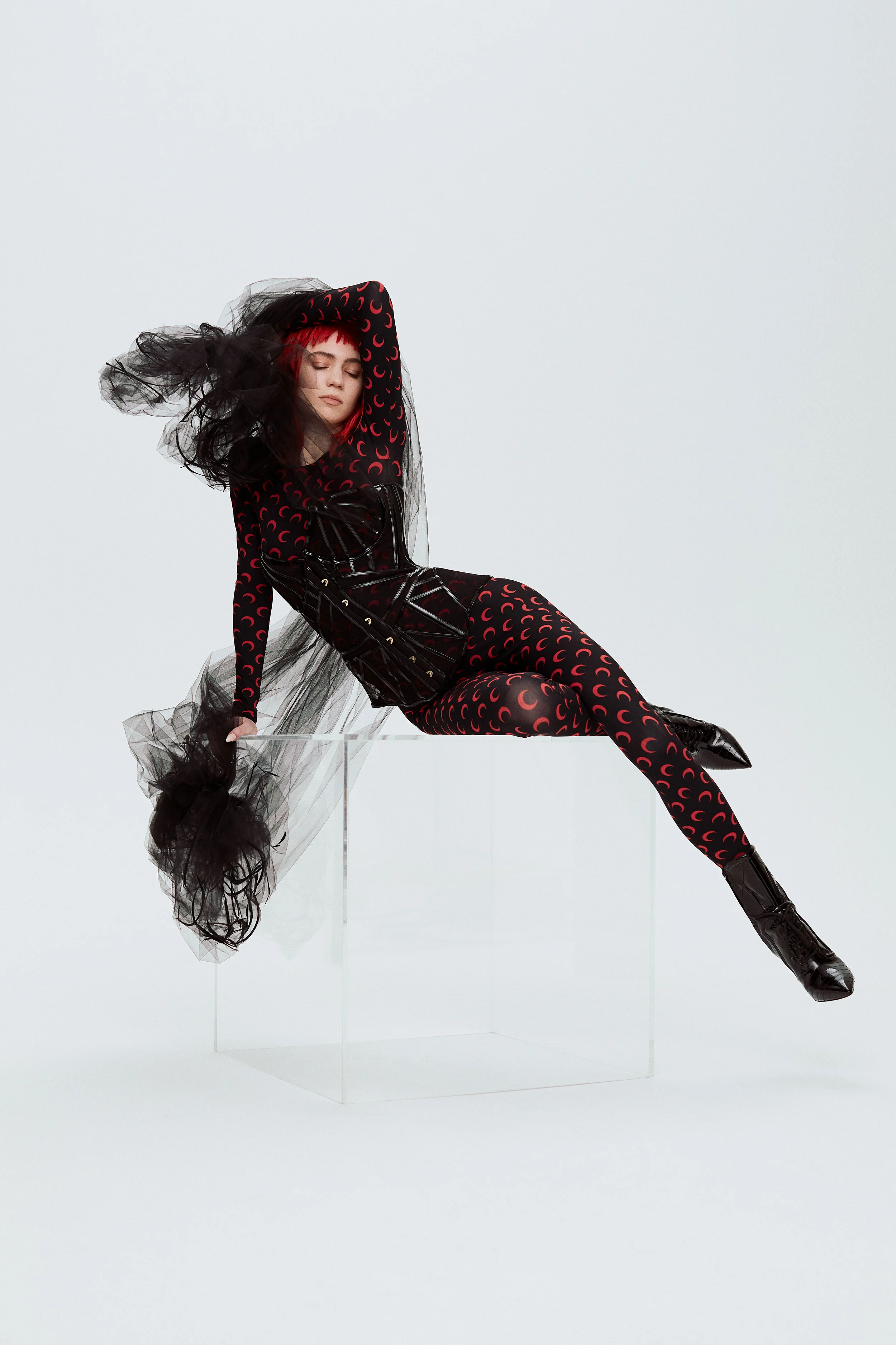 ALIONA KONONOVA cape, MARINE SERRE bodysuit, AGENT PROVOCATEUR bustier, and MOSCHINO boots.