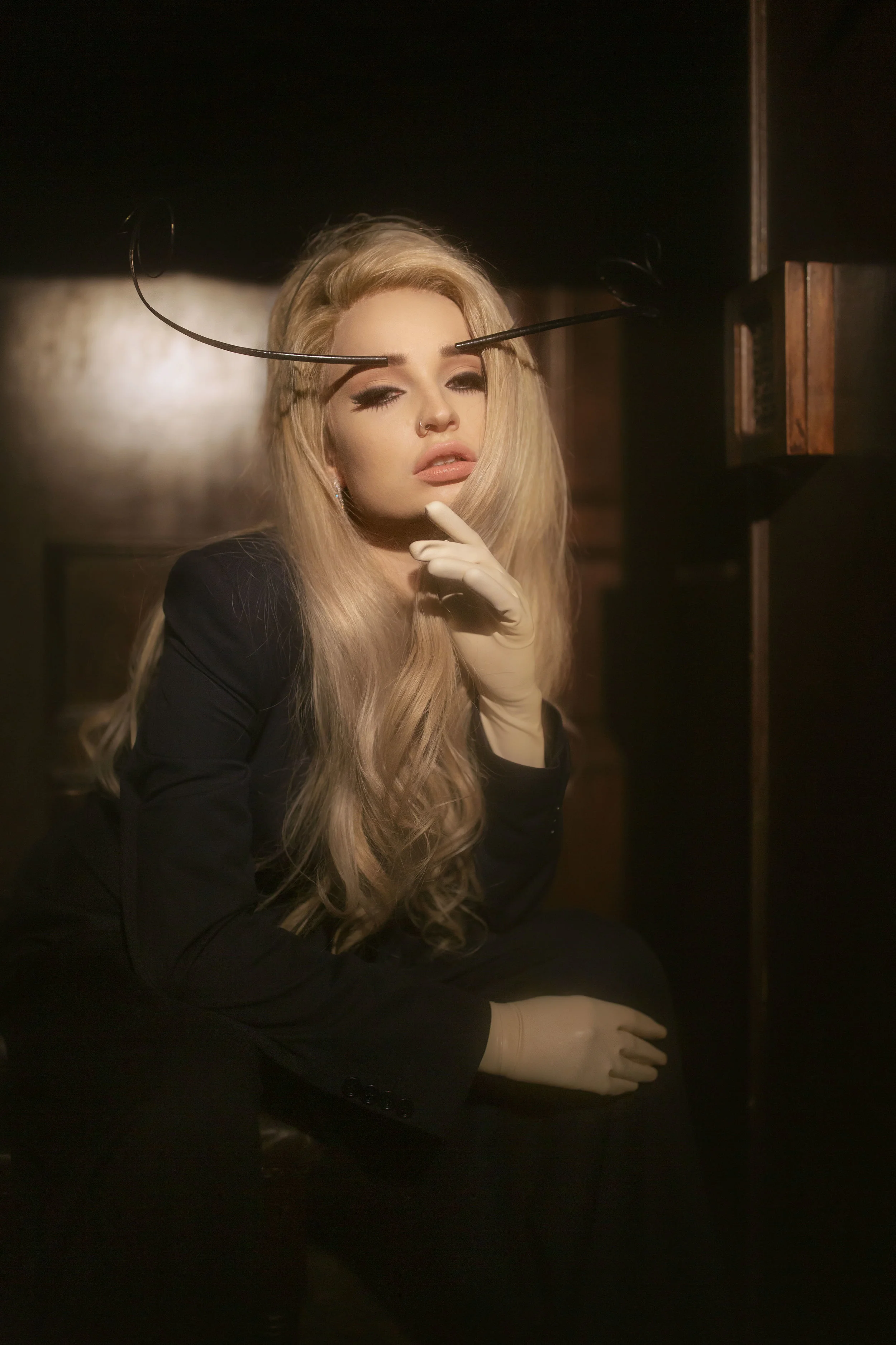 DRIES VAN NOTEN suit, PIERS ATKINSON headpiece, VEX gloves, and APM MONACO earrings
