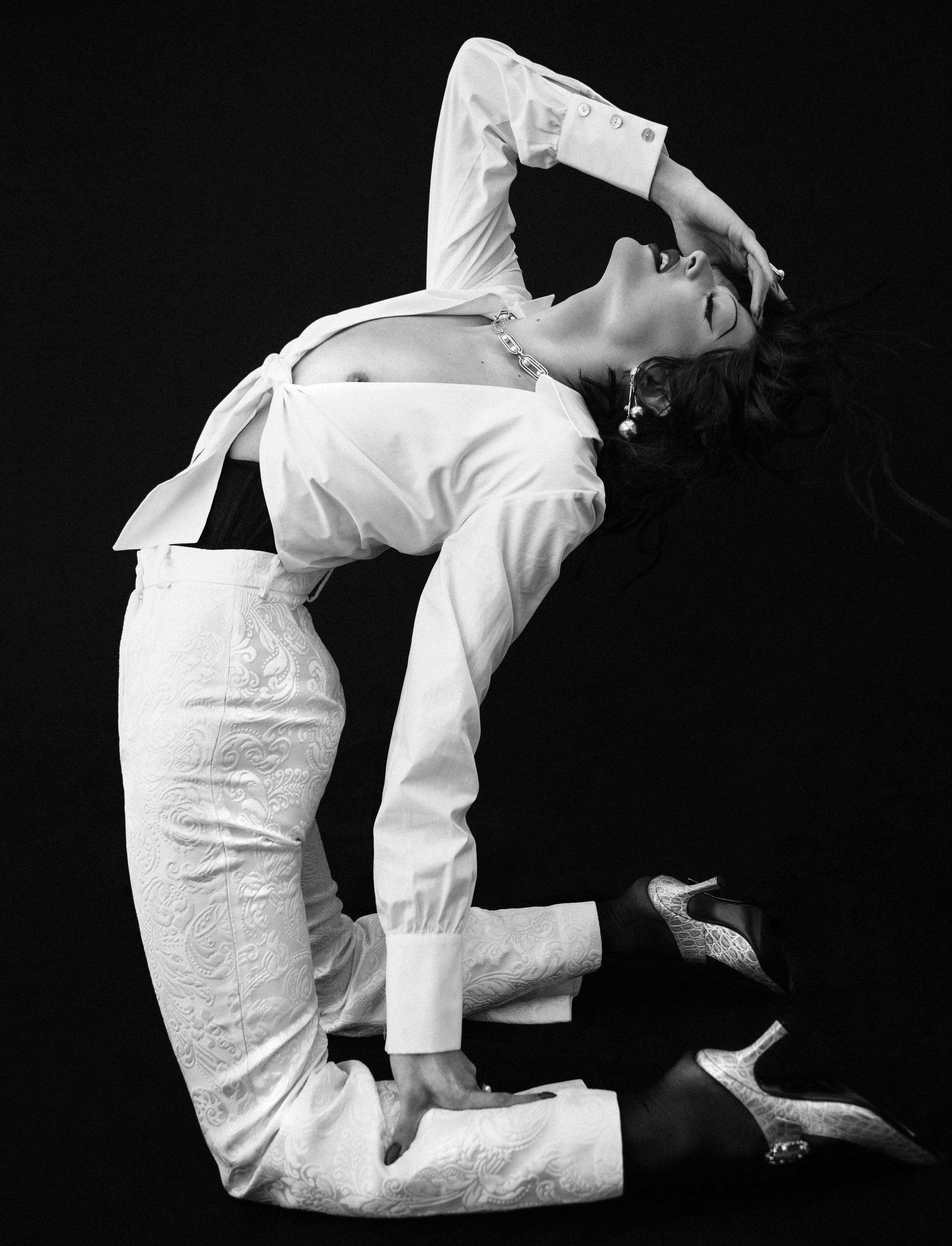 PALOMO SPAIN top and pants at Please Do Not Enter, WOLFORD tights, ERDEM shoes, STATE PROPERTY necklace and ring, and talent’s own earrings.