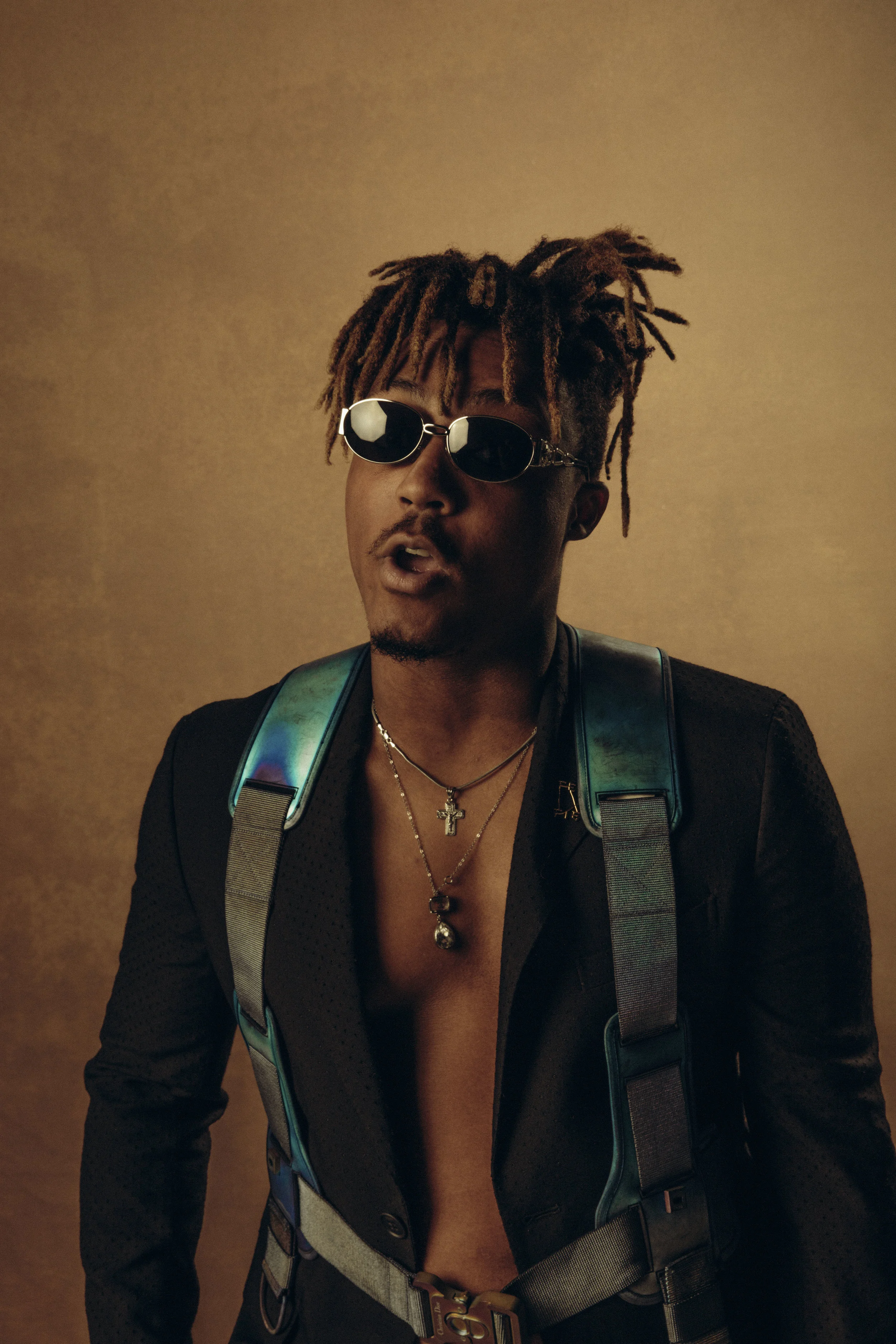 FENDI suit, DIOR MEN harness, vintage VERSACE sunglasses available at thevintagetrap.com , and talent’s own jewelry