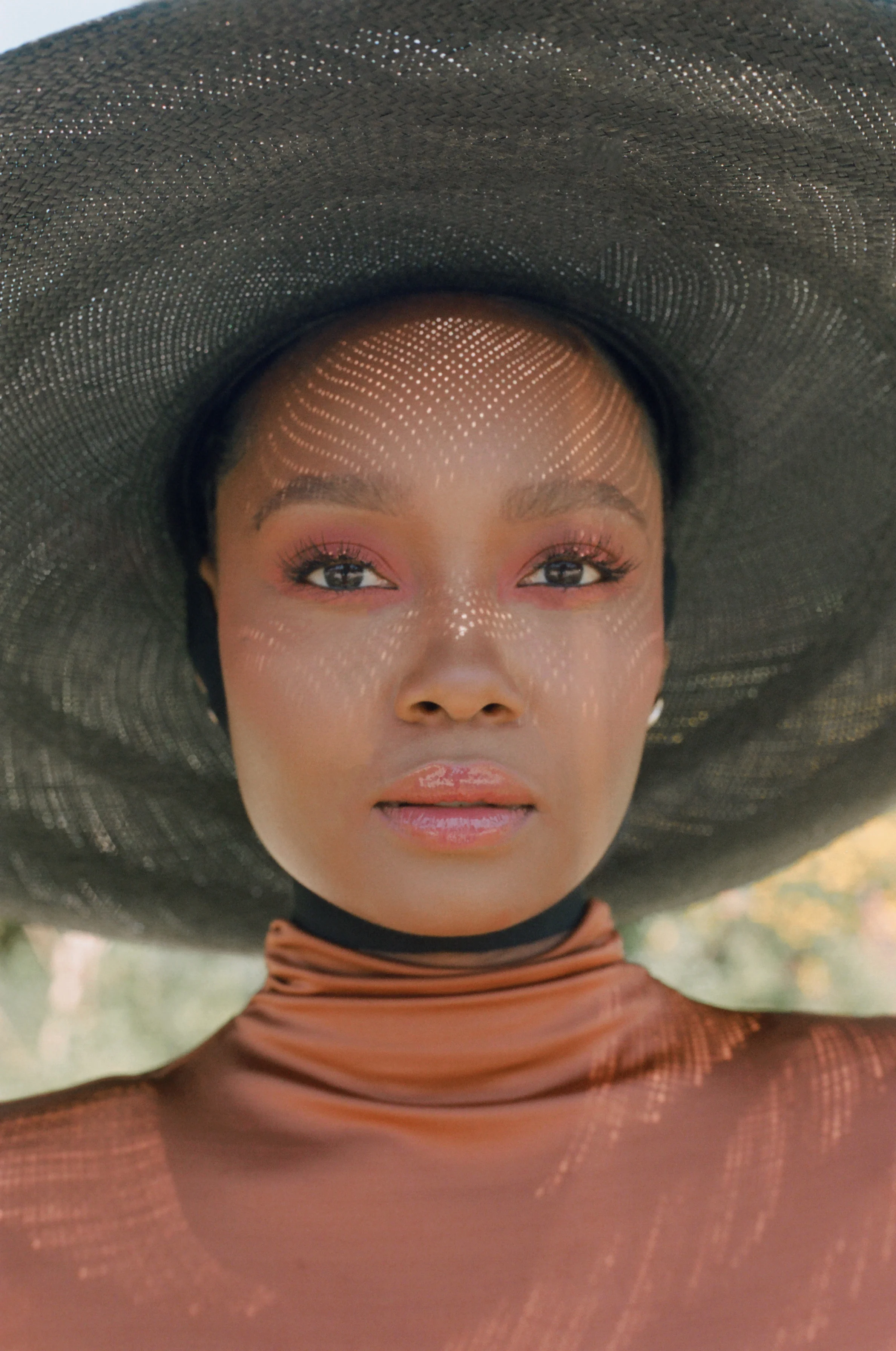 LE PIACENTINI dress, WENYUAN earrings, and GLADYS TAMEZ MILLINERY hat.