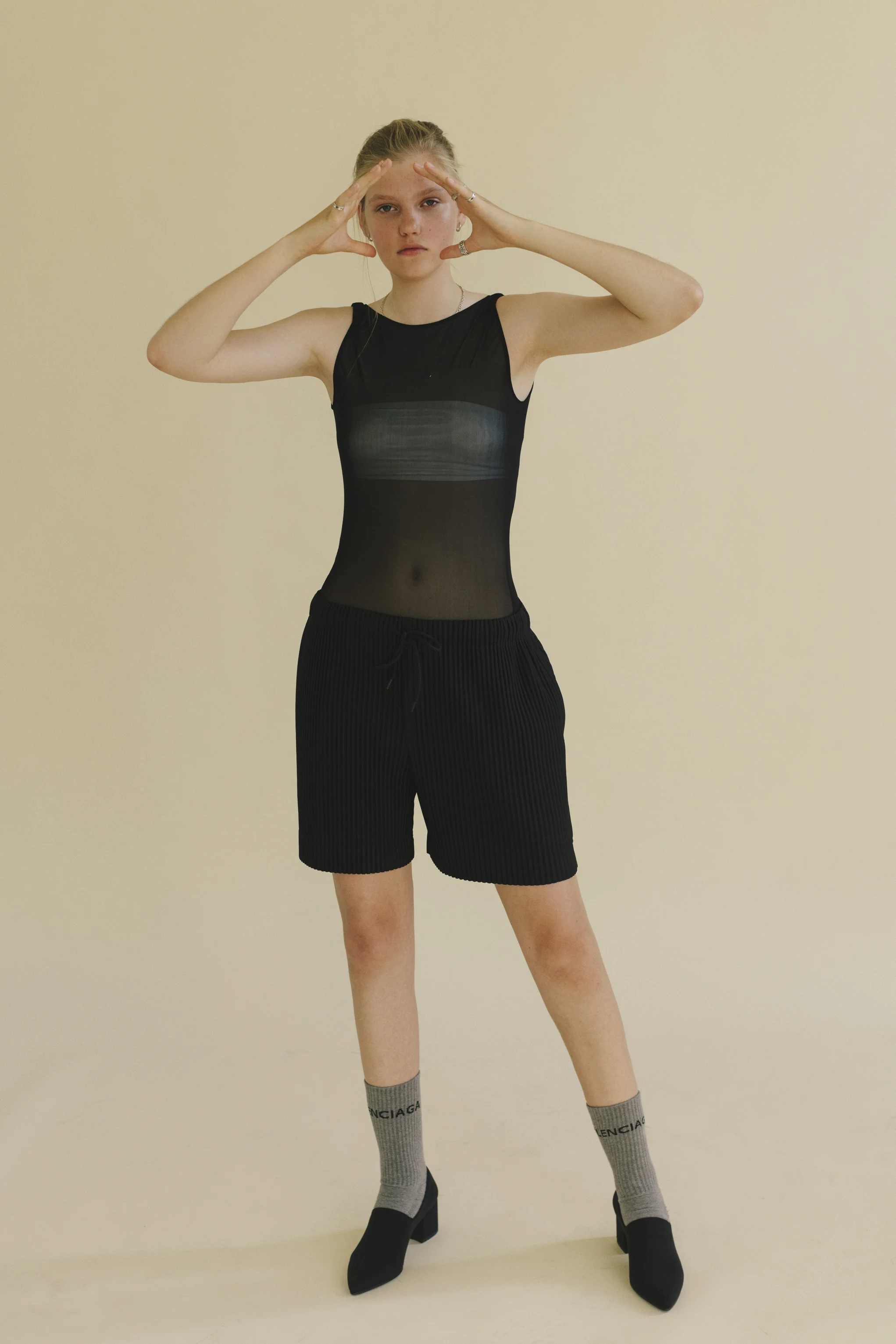 MAISON MARGIELA bodysuit, ISSEY MIYAKE HOMME PLISSE bottoms, VAGABOND shoes, and BALENCIAGA socks.