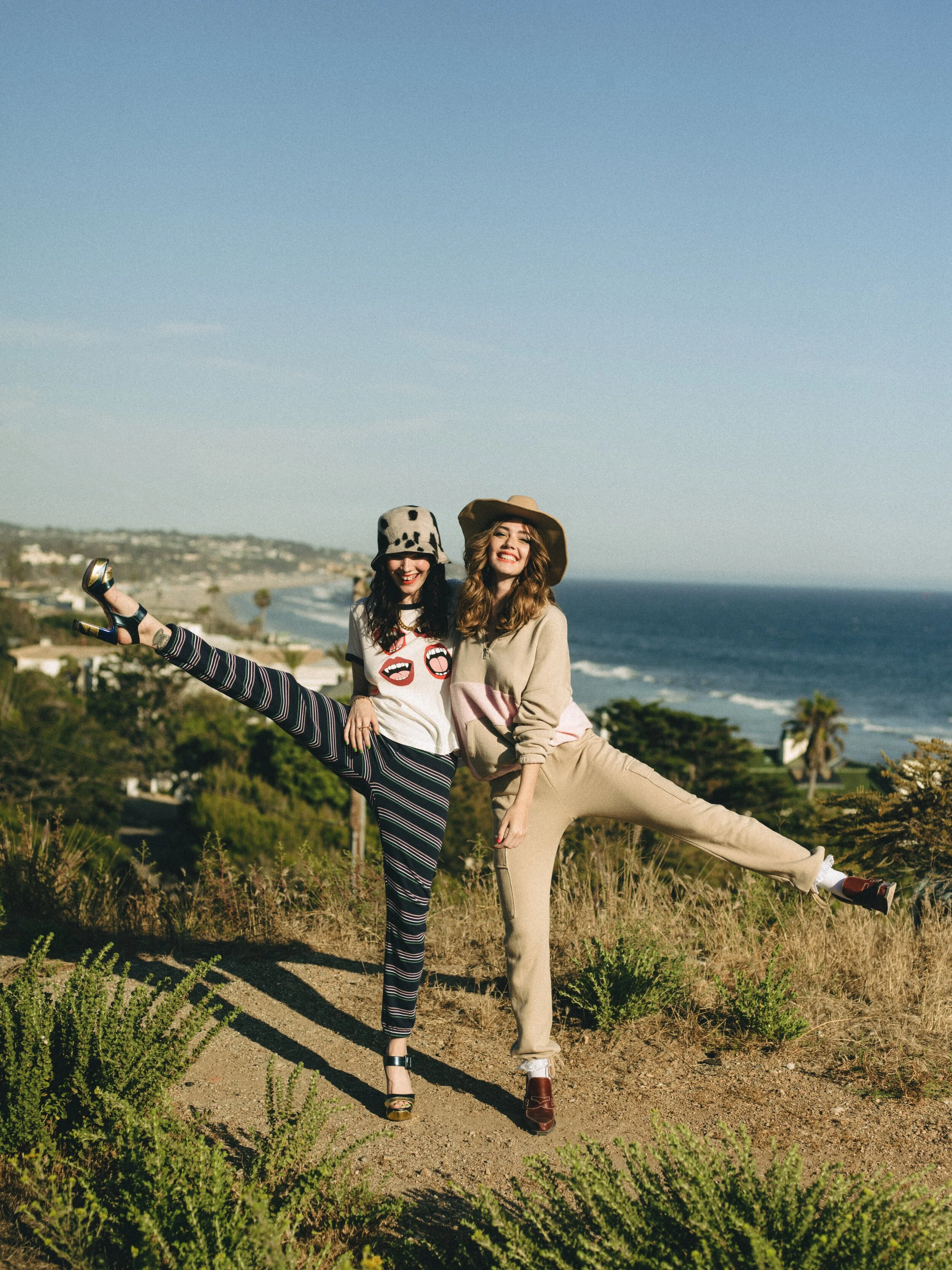 Left to right: CLYDE hat, JF LONDON shoes, stylist’s own necklace, LADY GREY ring, NORA KOGAN ring, ONIRIKKA ring, and TARA bracelet. CLYDE hat, HARDEMAN shoes, stylist’s own socks, NORA KOGAN ring, and LADY GREY earrings.