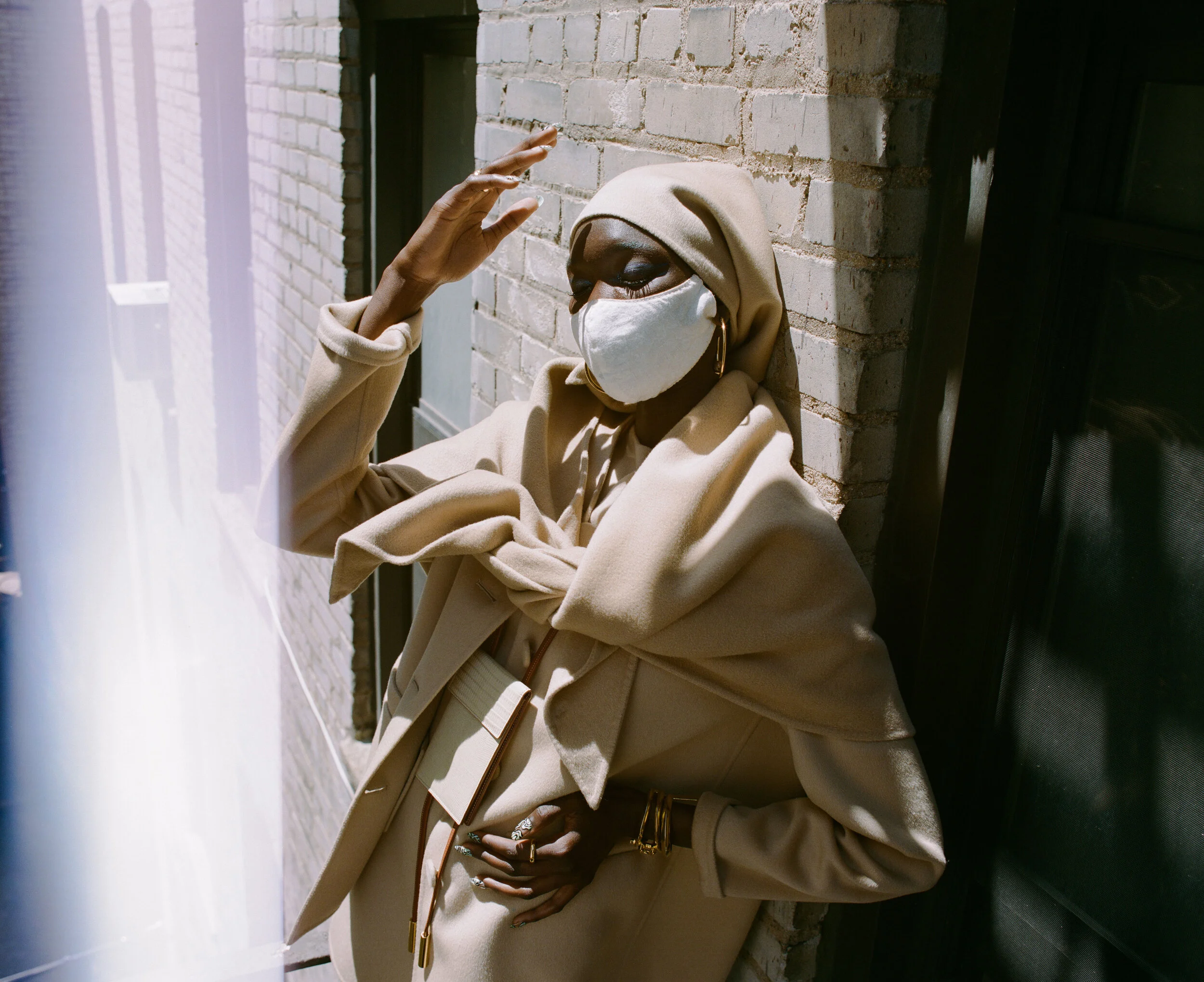 MARC JACOBS jacket, dress, shawl, leggings, shoes, and headscarf, ASHYA wallet bag, KHIRY earrings and ring, THIRD CROWN arm bracelets and ring and model’s own mask.