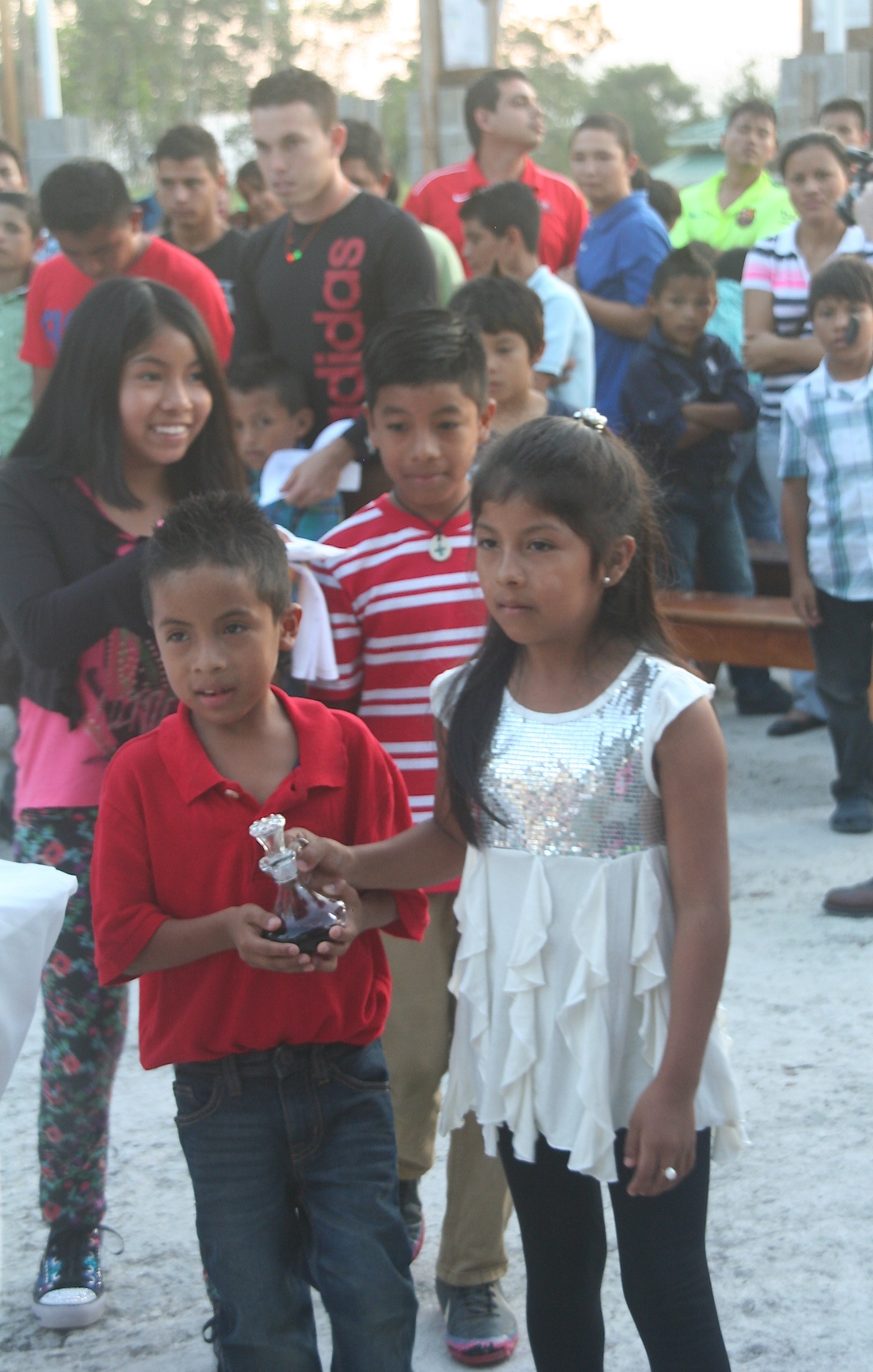 Carmen* and her siblings presenting the gifts at a mass with Fr. Dennis in January.