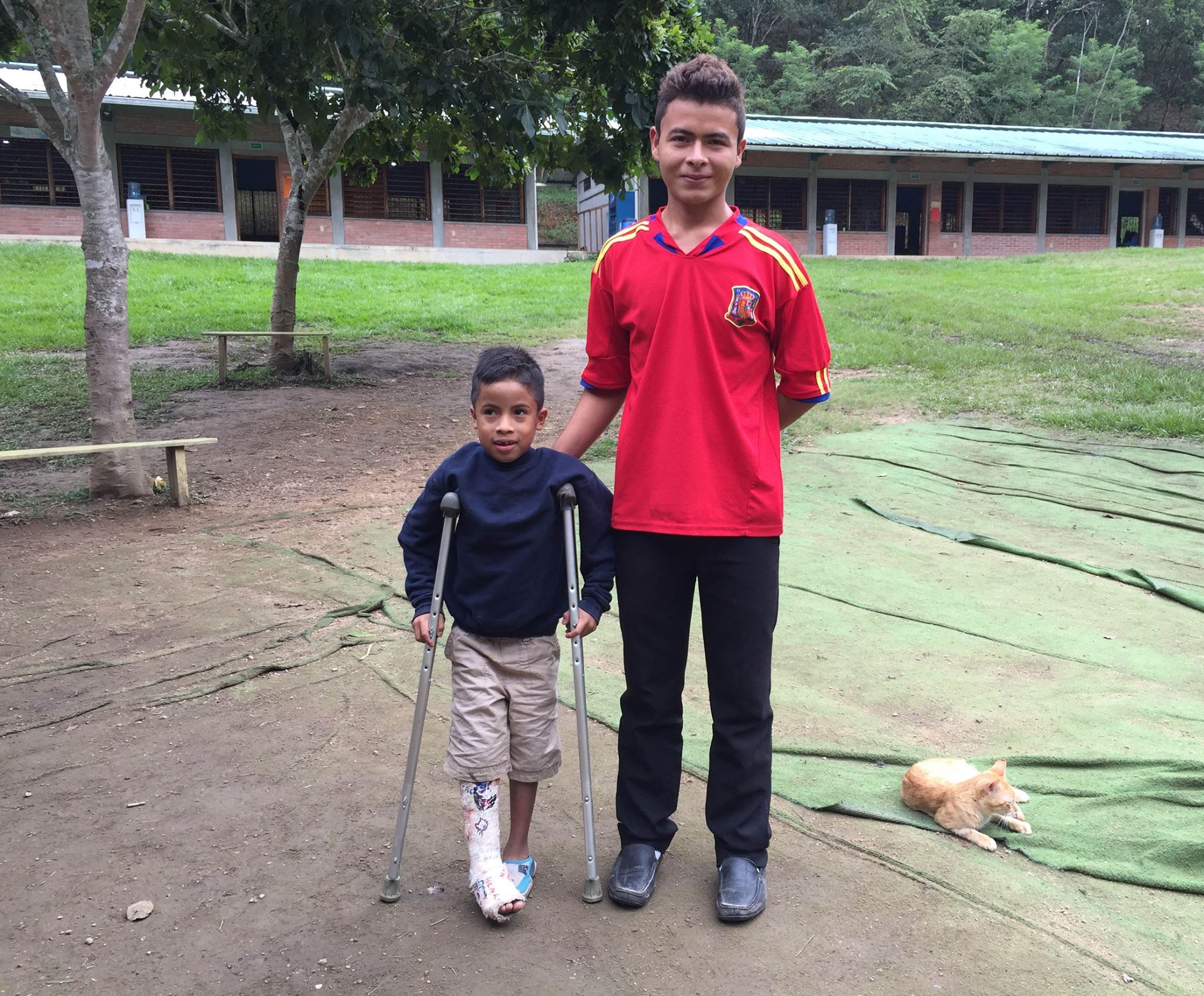 Dominic assisting one of our younger students at the Amigos school during his vacations from colegio (high school)