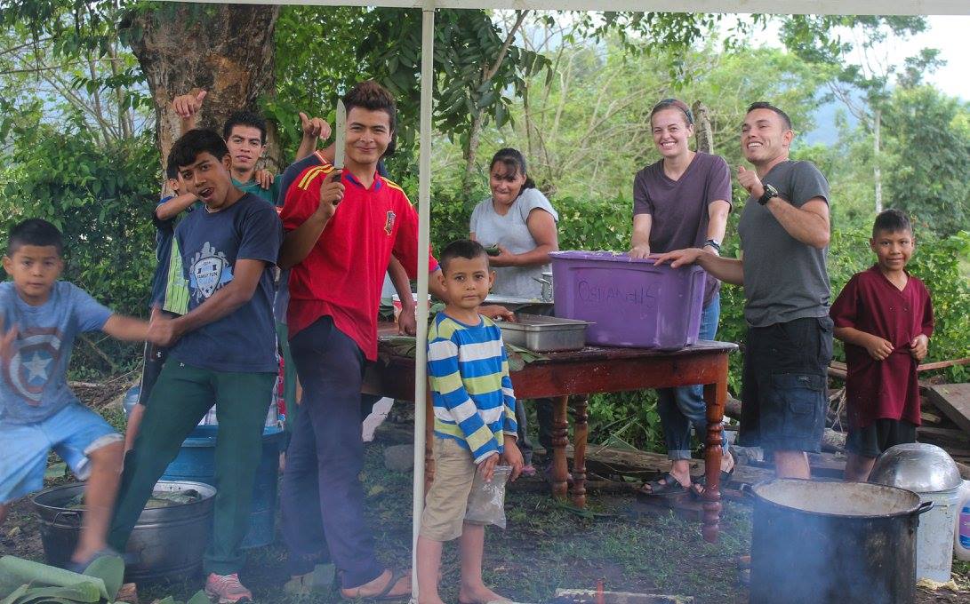 Dominic (red shirt) helping make tamales for Christmas
