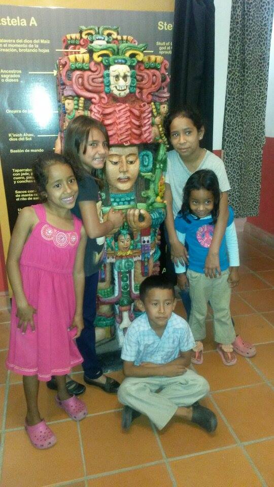 Rosa* (top right) with her two younger sisters (pink dress and blue shirt), her younger brother, and a friend.