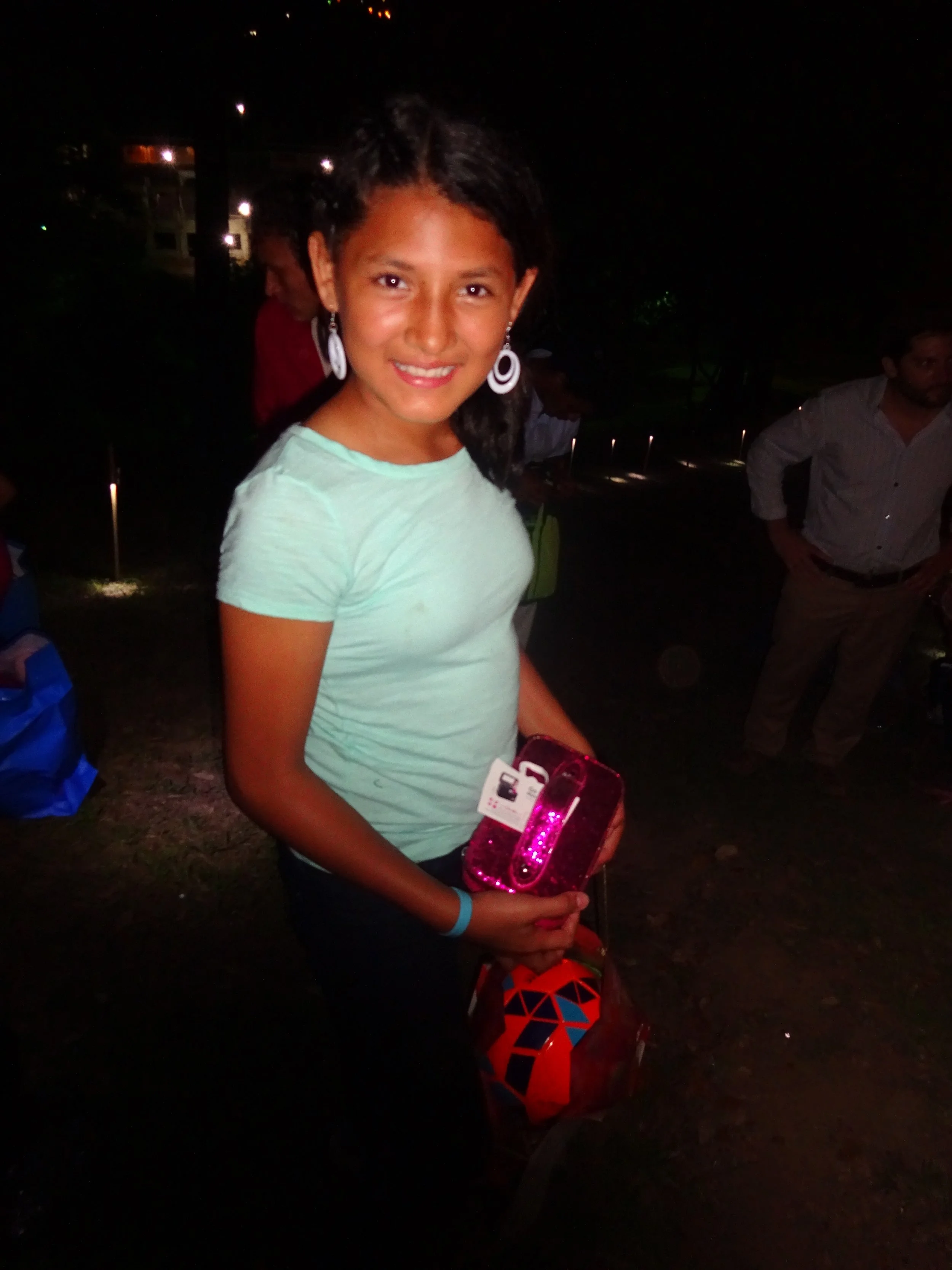Maria receiving presents donated by her padrinos from the U.S. on Christmas last year
