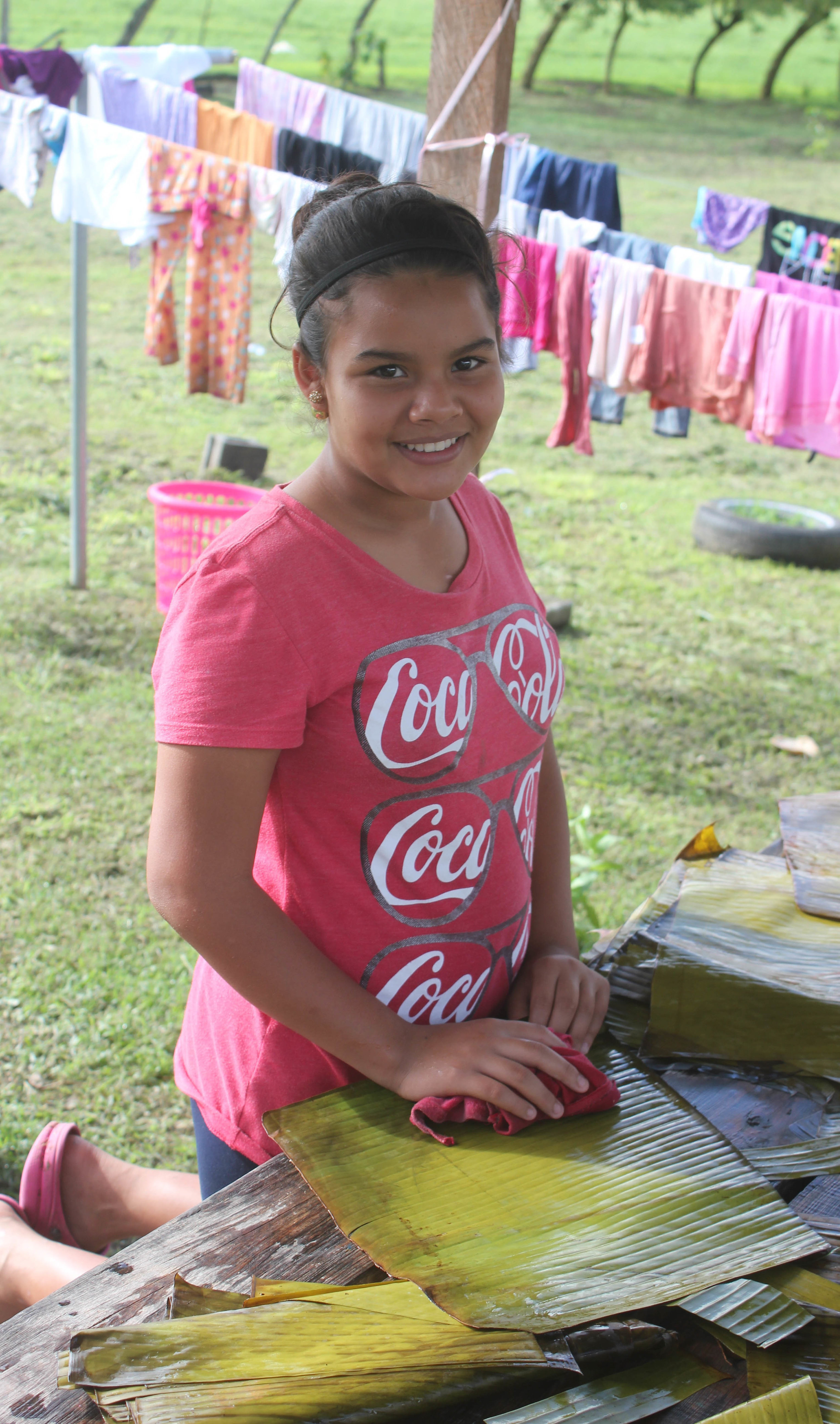 Elena* helping make tamales on the morning of Christmas Eve - a tradition in Honduras and at Amigos.