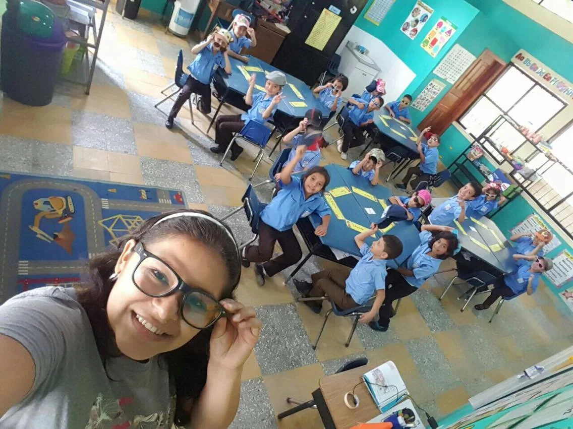 Profe Karen with her first graders getting ready to go on an exploring mission!