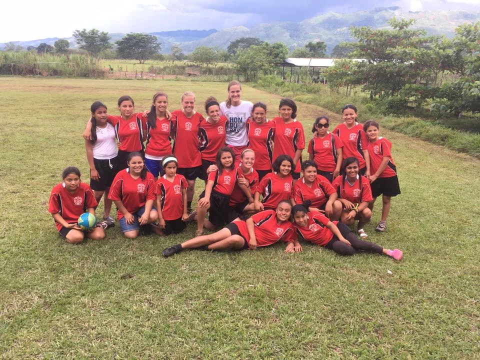 In addition to working at our school, Profe Jeidy is active in our kids lives outside of school. Here she's pictured with several other volunteers, teachers, 'madrinas,' and older girls after a soccer tournament.