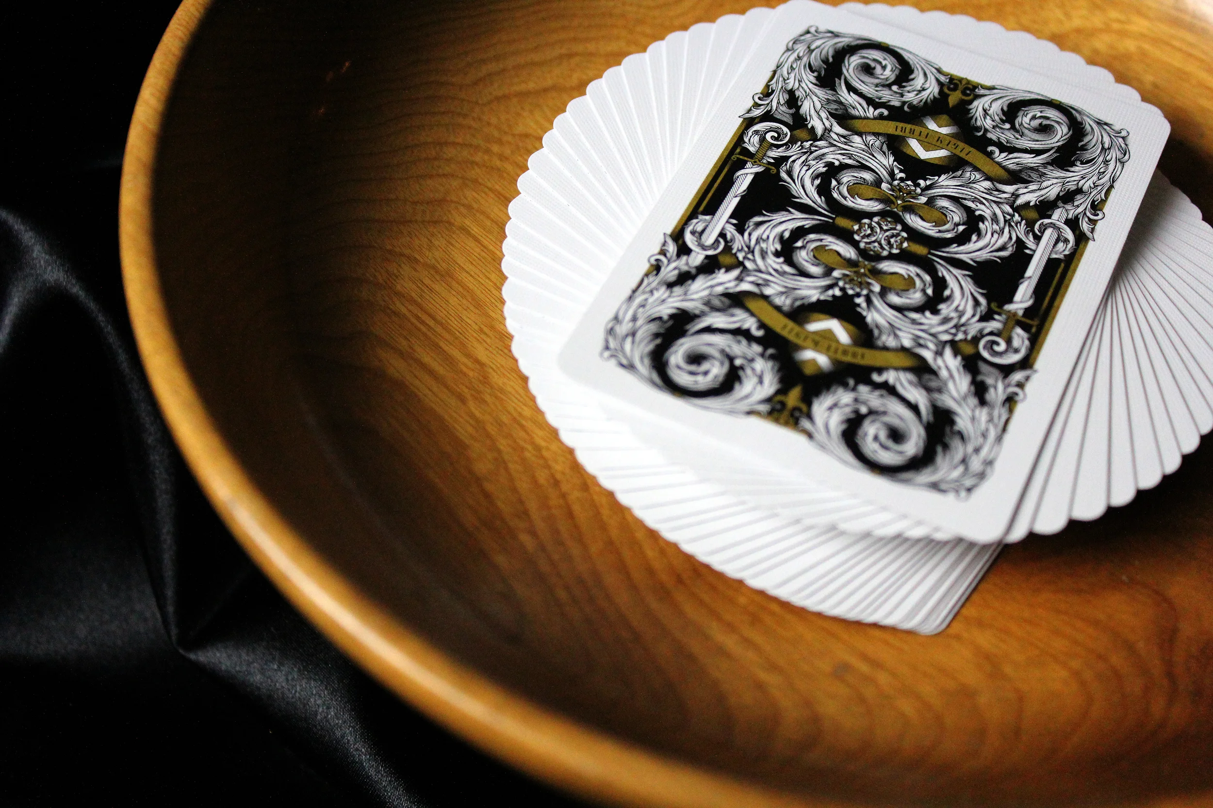  The Rebels deck is featured in white, displaying intricate linework and a composition showing multiple "regions" to symbolize all the different barons uniting against the King. Together the ribbon from the Rebels deck and the Royals deck unite to cr