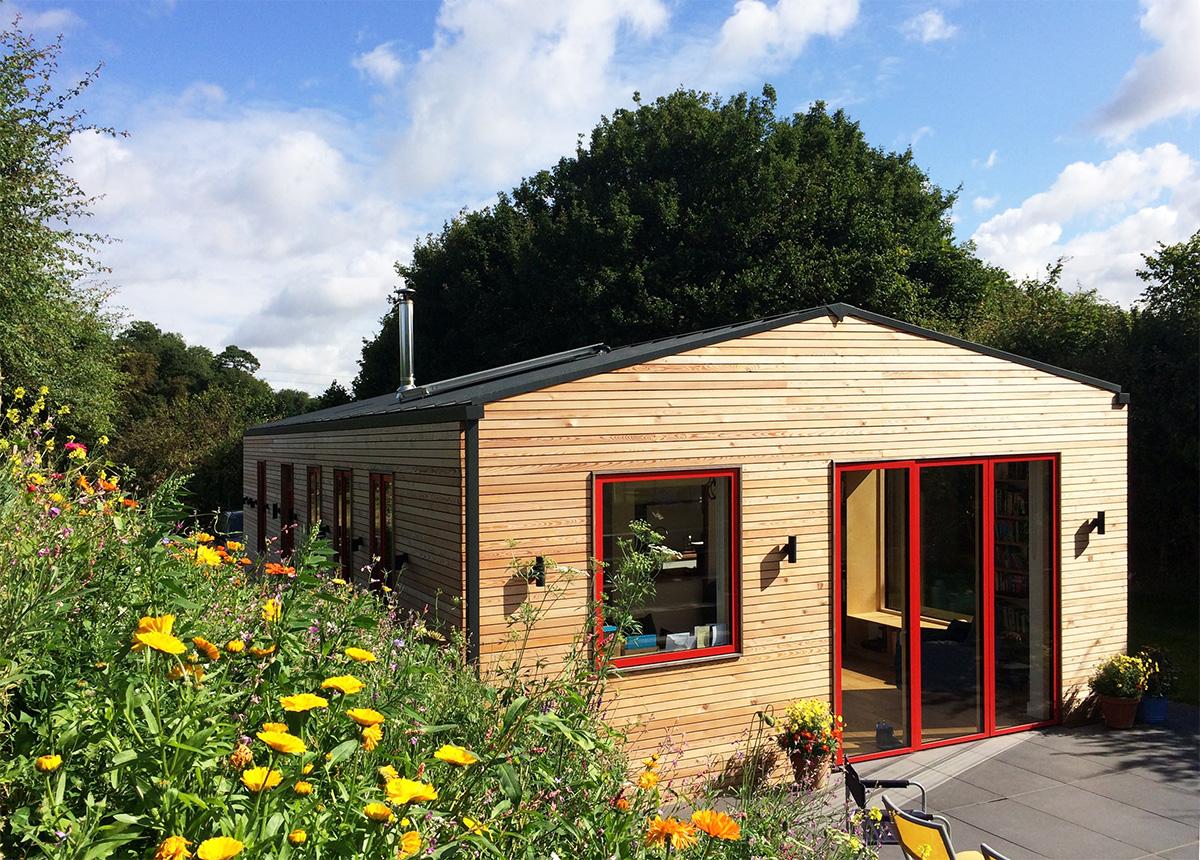 Beautiful view of off-grid eco dwelling near ipswich with meadow flowers out on a summers day