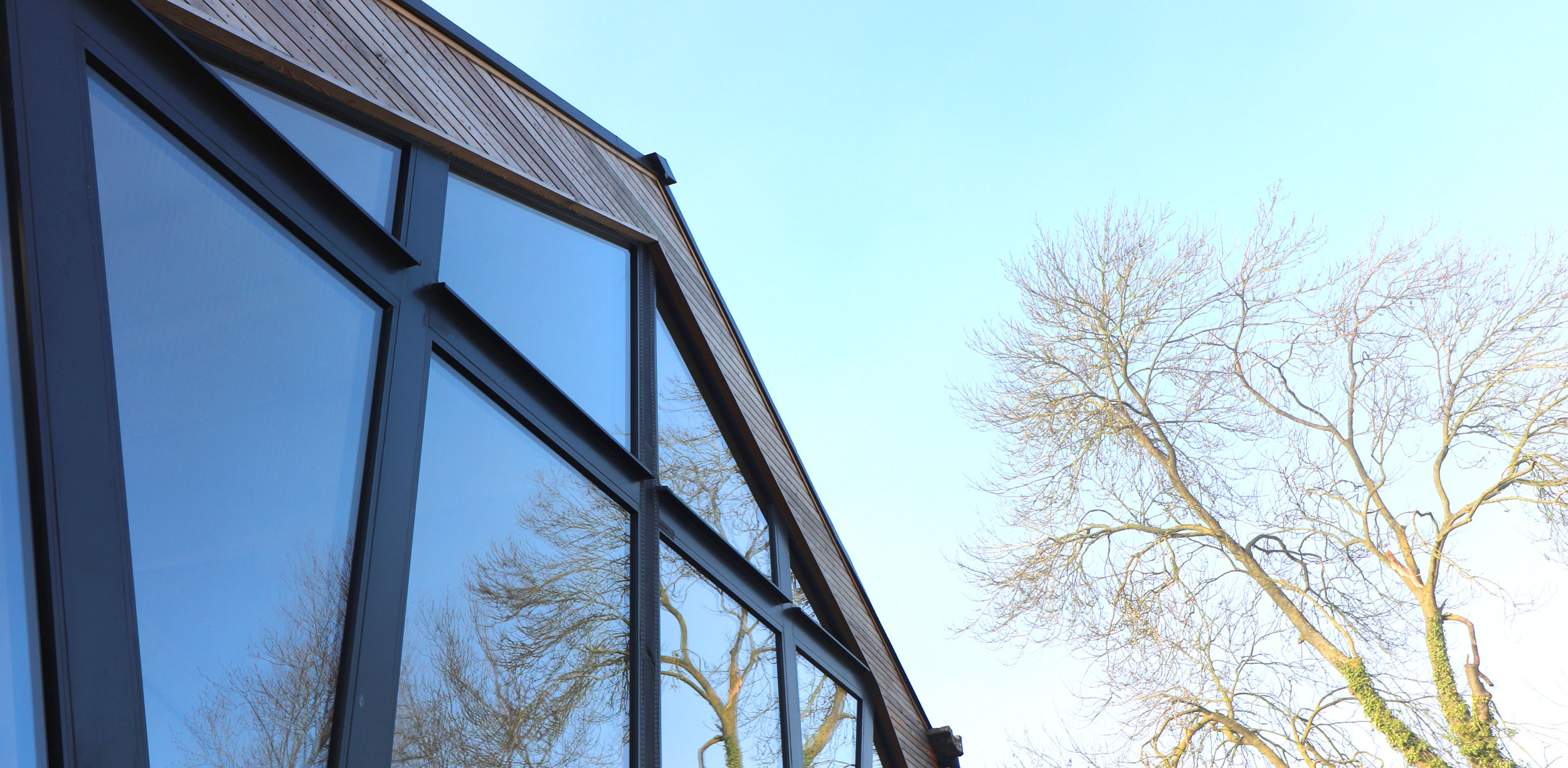 reflection in glass of gable end to barn conversion