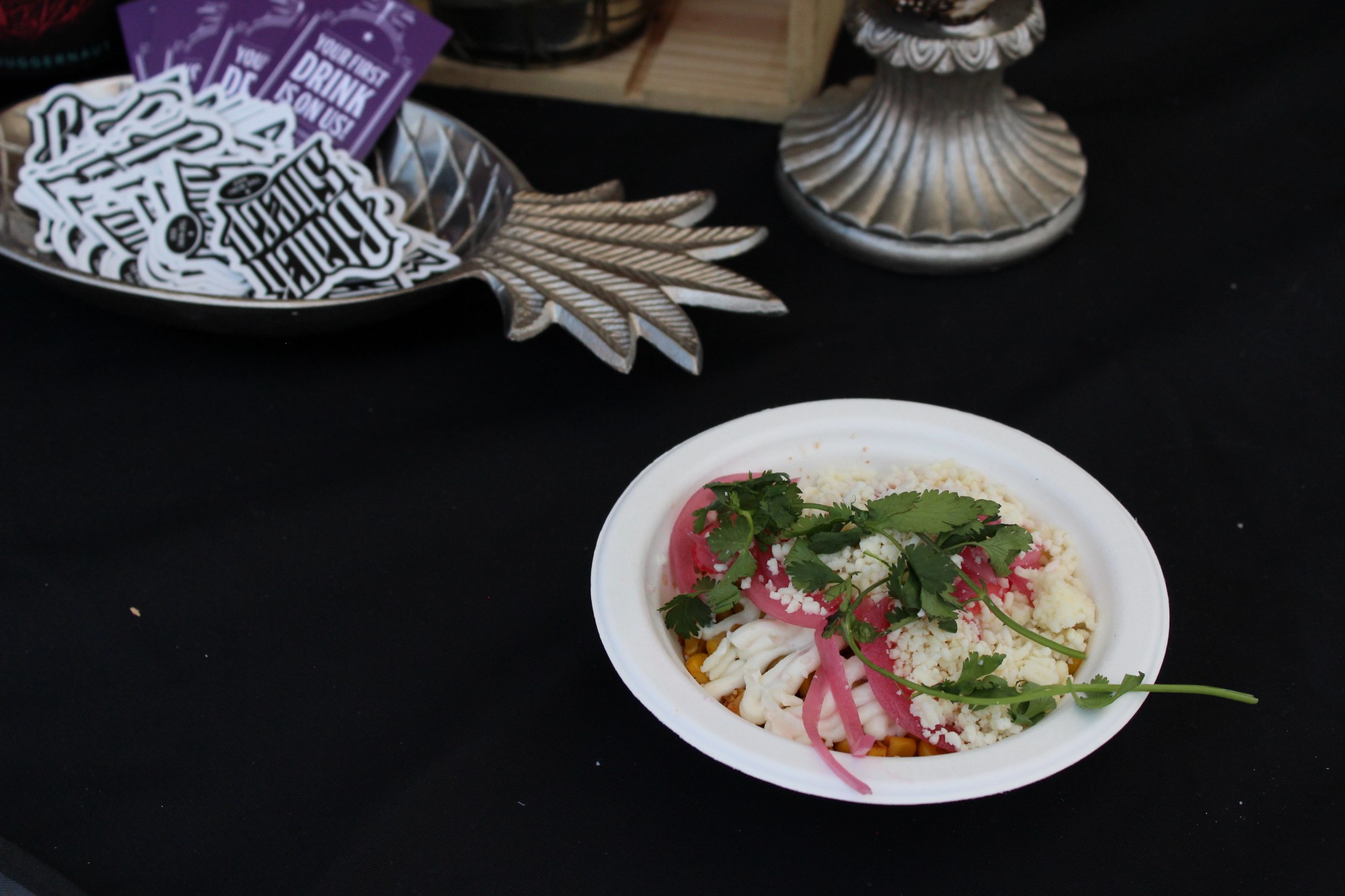Dish from Black Sheep MKE: Charred Corn with pickled onions, cotija cheese, picante sauce and a garlic crema.
