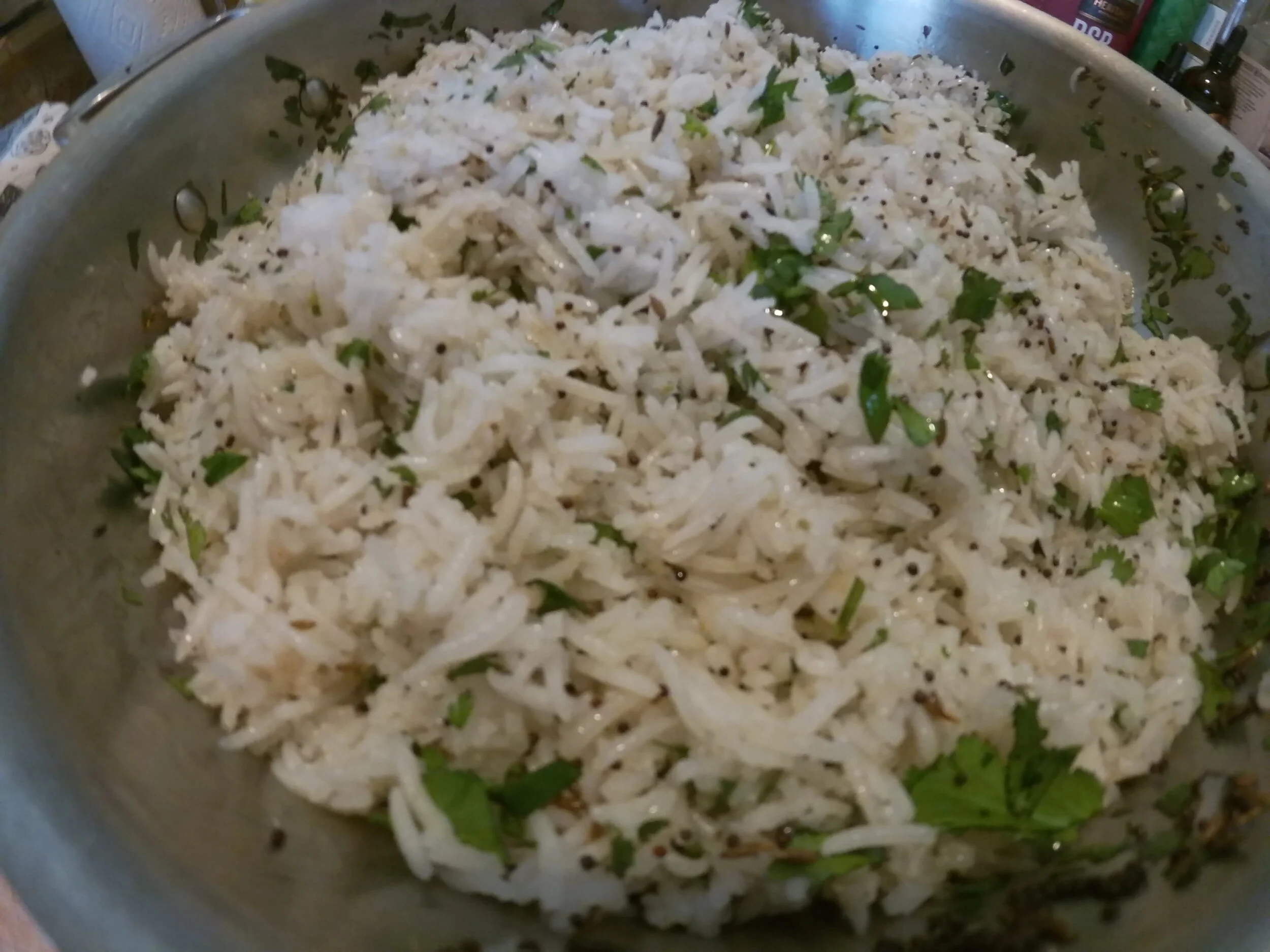 14. Toast spices in ghee, add cooked rice and cilantro