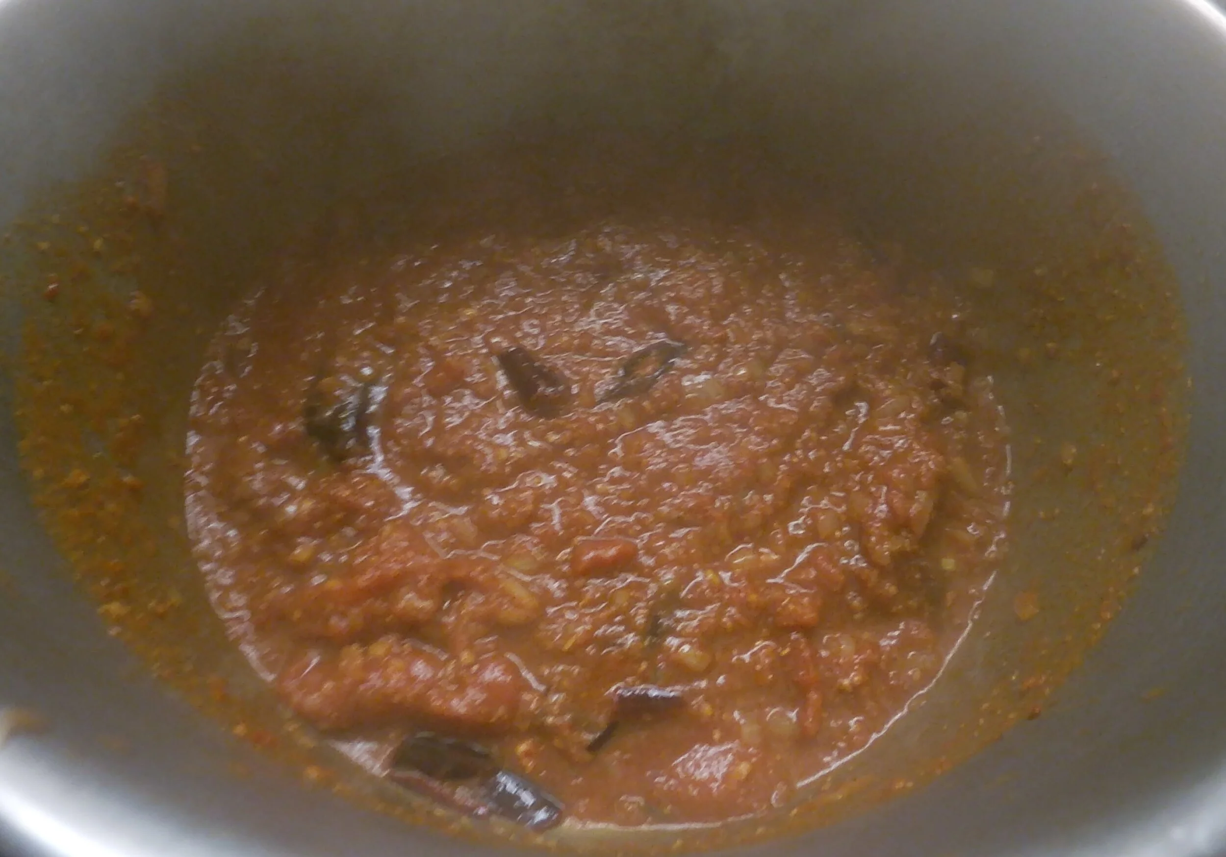 5. Add tomatoes and cook down