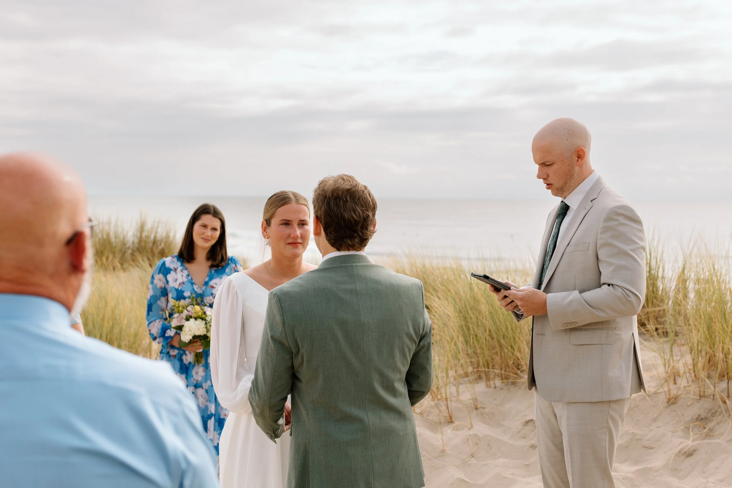 Bride tearing up looking at her groom at cannon beach oregon