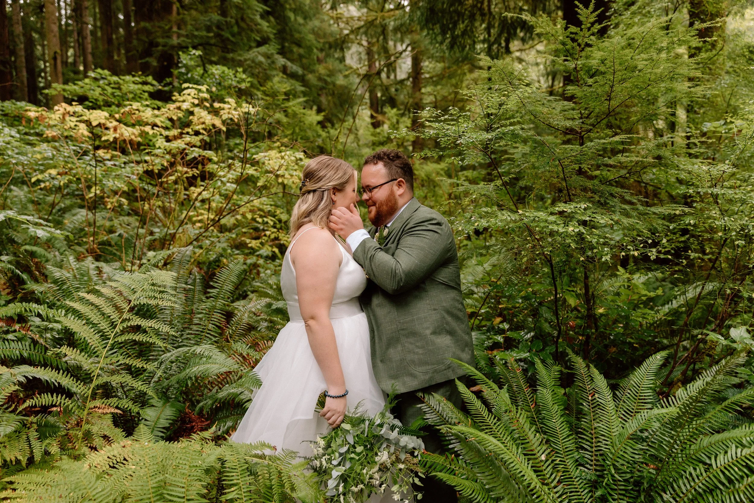 Bride and groom kissing in the trees