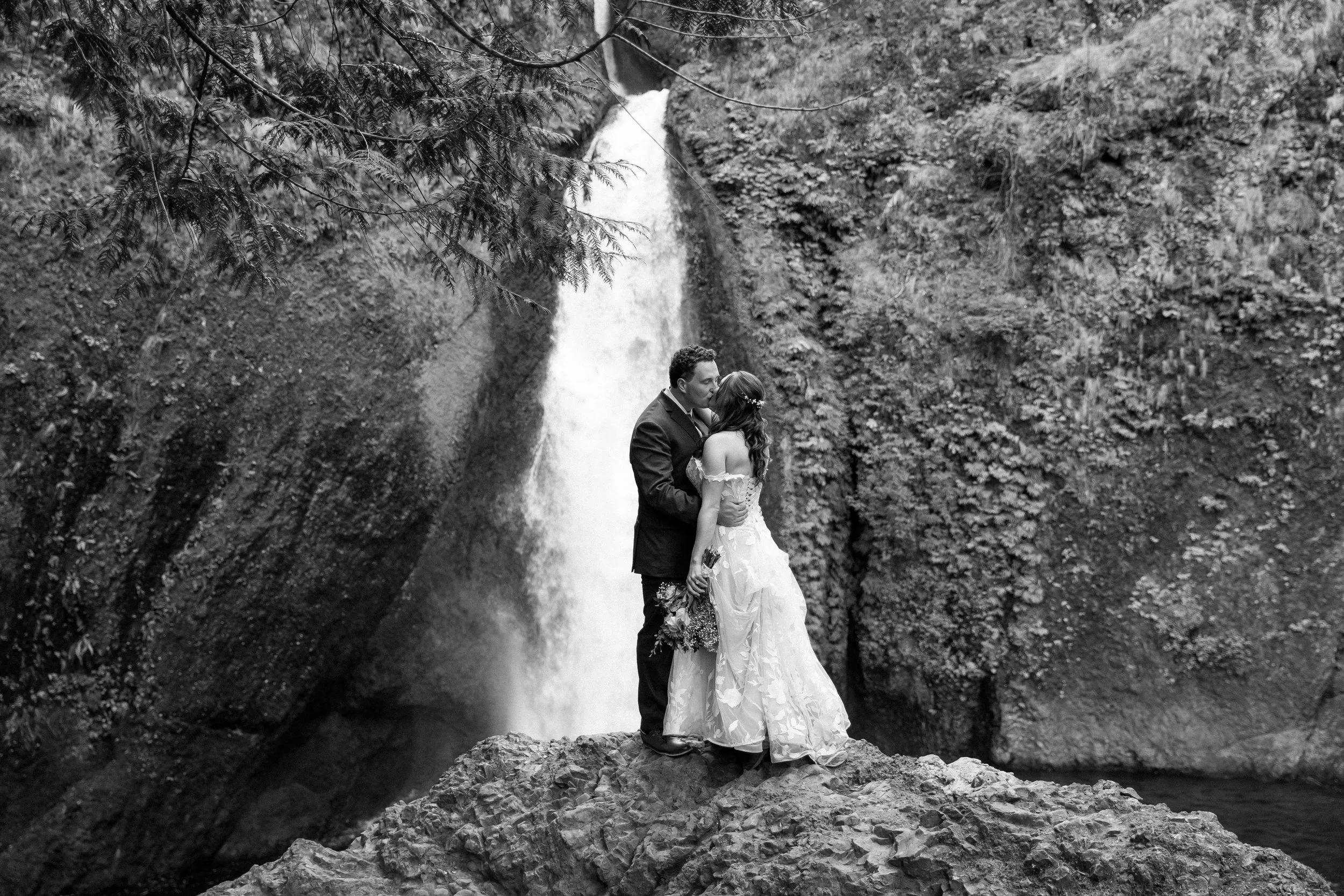 Bride &amp; Groom kissing during the elopement at Wahclella falls